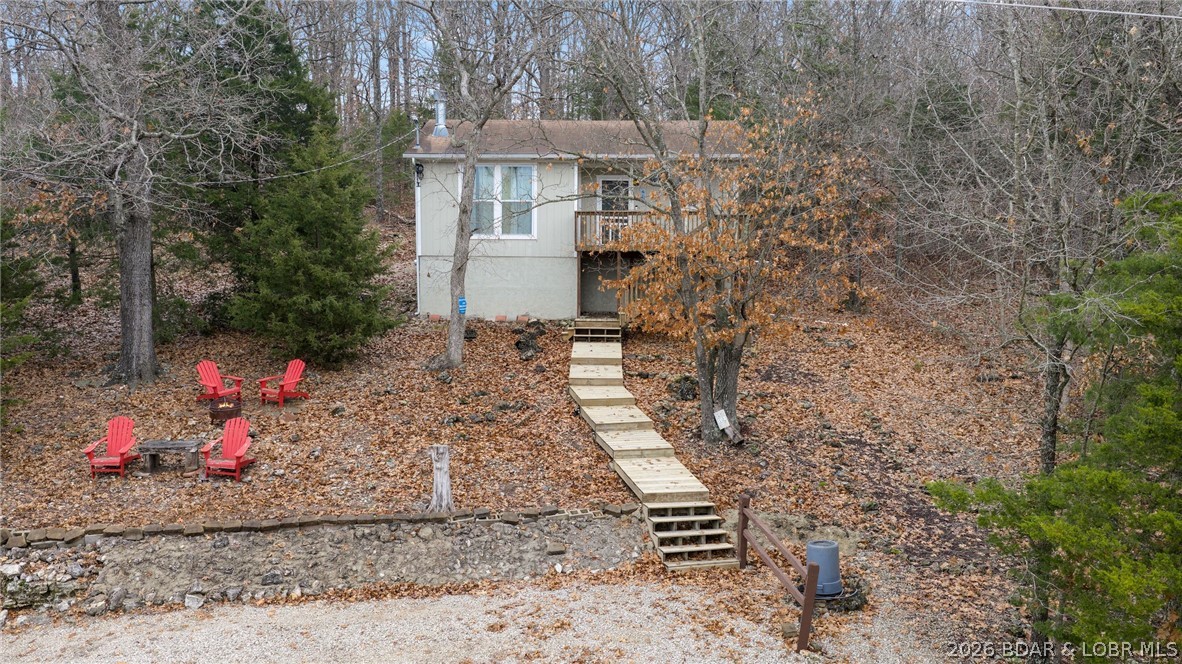 Priced to move and set along the edge of a serene 20-acre man-made lake at the entrance to Indian Creek Cove, this inviting 2-bedroom, 1-bath cabin offers the perfect place to unwind. Though just 15 minutes from Bagnell Dam, it feels like a secluded retreat. Inside, a cozy stone fireplace creates a warm atmosphere for cooler days, while sunny weather invites you to kayak, fish, or simply relax by the water. Outdoors, a fire pit provides the ideal spot to wind down and enjoy picturesque views of two lakes. The crawl space has been upgraded with spray-foam insulation and a vapor barrier, enhancing comfort and energy efficiency throughout the year. An additional lot with a day dock is also available for $30,000. If you’re searching for a charming lakeside escape, this cabin is a wonderful find.