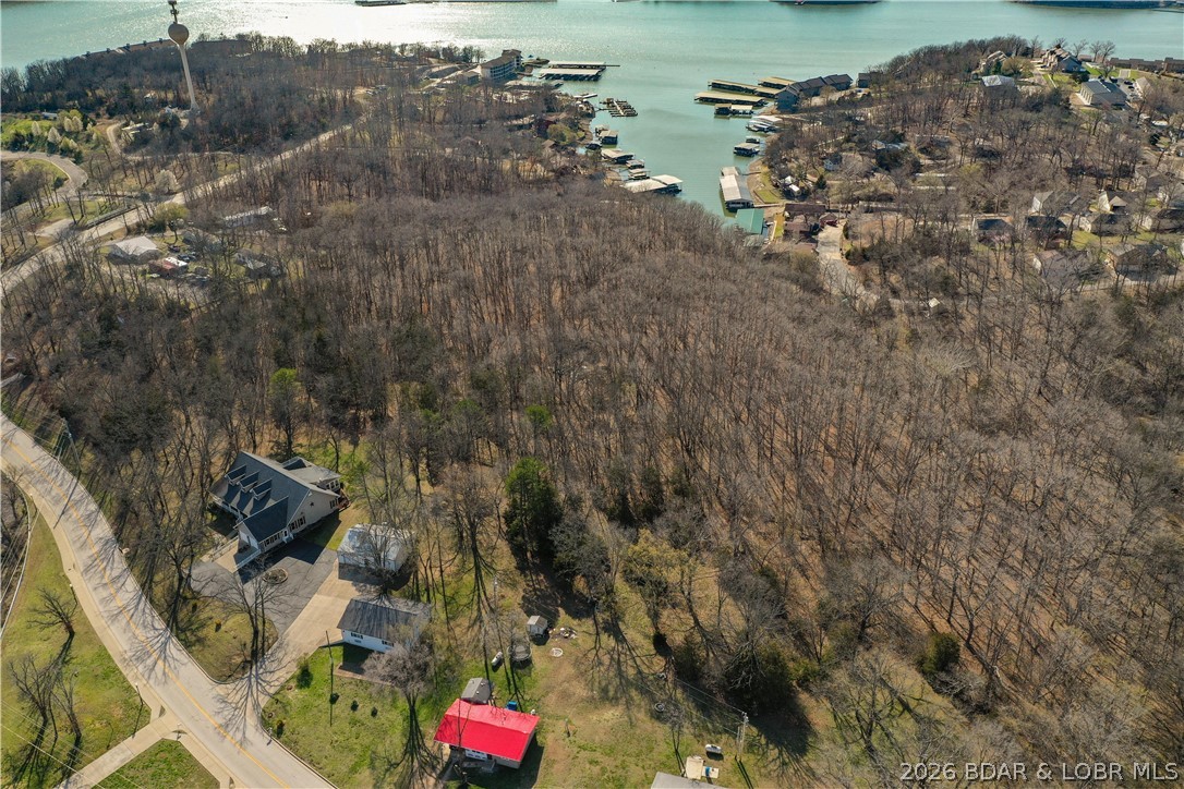 Nearly 16 acres (15.8) of undeveloped land off Passover in Osage Beach, City water and city sewer is available, NO HOA!.  300' foot of waterfront at the waters edge with plenty of level area, a two well dock USED to exist at waterfront at one time (see pics) and permitted.  Property is zoned RB1 which allows multifamily, shouse (garage-with living space), patio homes and residential as well.  Three entry points and three tax id's which can be divided any way you like.  Located in the heart of Osage Beach where new developments, shopping and restaurants have been rising over the years.  Take a look at the plat attached and check it out - it could be your next development or family retreat!
