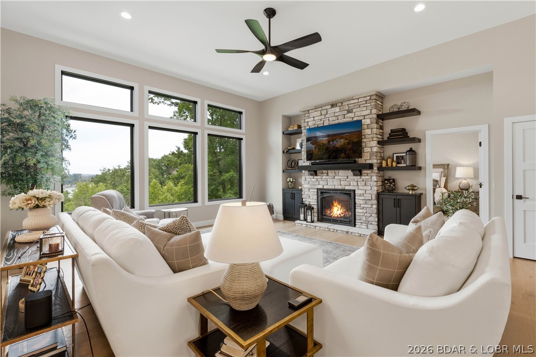 Prepare to be impressed by this stunning custom-built Thomas Construction home, where luxury craftsmanship and thoughtful design come together in one of Cross Creek's most desirable gated communities. Every detail showcases top-of-the-line finishes including heated bathroom floors, Andersen 400 Series windows, custom window treatments, and a striking floor-to-ceiling stone gas fireplace. The open-concept design captures incredible lake views and flows effortlessly to expansive Trex decking with both covered and screened outdoor living spaces. The spacious lower level features a John Deere room w/concrete golf cart path access, perfect for a side-by-side, golf cart, mower, and lake toys, plus an oversized 3-car garage. Includes a 12x32 boat slip in the community dock, offering all the benefits of lake living w/out private dock maintenance. An additional subdivided vacant lot next door is included, providing endless possibilities for future expansion, a private pool oasis, or the opportunity to sell it separately. Located in the gated golf cart-friendly Cross Creek community w/ a clubhouse, pool, and playground, this impeccably maintained, magazine-worthy home is truly one of a kind.