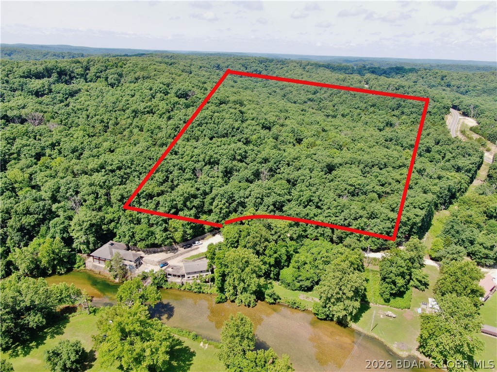 Rare opportunity to own 18 unrestricted acres with direct access to the Bank Branch River, stunning Lake of the Ozarks views, and Ha Ha Tonka State Park bordering the back of the property. With no HOA and no building restrictions, the possibilities are endless—build your dream home, barndominium, family retreat, or recreational getaway.

This unique property offers the best of both worlds: peaceful seclusion surrounded by nature while still enjoying beautiful lake views and easy access to the water. The adjoining state park creates an expansive natural backdrop, giving you the feeling that your backyard stretches for miles.

Outdoor enthusiasts will love the exceptional opportunities for fishing, hunting, kayaking, hiking, and wildlife watching. Enjoy direct river access, abundant wildlife, mature timber, and unmatched privacy that's increasingly hard to find at the Lake of the Ozarks.

Ideal for a custom home, cabin, recreational property, or investment
If you've been searching for acreage that combines water access, lake views, and the freedom to build what you want, this is a truly exceptional property.