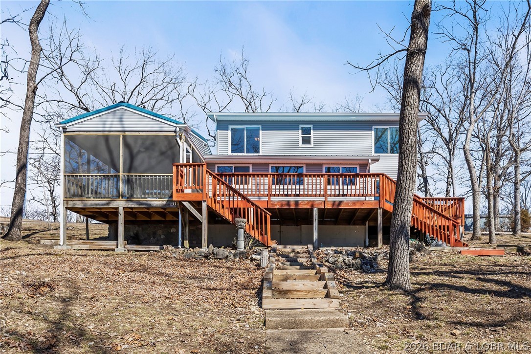 Newer metal roof, gutters & downspouts, newer vinyl siding, newer LVP flooring, beautifully updated kitchen with stainless steel appliances, custom cabinetry, and quartz countertops. Nothing to do except enjoy the big lake view of the 7MM of Lake of the Ozarks through the new windows. Lots of privacy and elbow room and entertaining areas - including a composite martini deck, patio over the boat garage, fire pit, large screened in deck and large open deck for the sun-lovers.Cabinets in the oversized 2-car garage/workshop stay. There's room to build more out buildings. Great location by road or water, close to restaurants, golf course, movie theater and shopping.