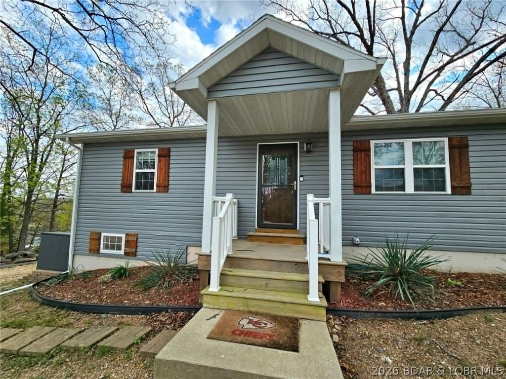 This charming 2 bed, 1 bath home offers incredible potential—easily convert it into a 3 bed, 2 bath by finishing the basement and adding instant value. A 10x20 boat slip is included, making it simple to start enjoying lake life right away. Just a quick half-mile drive brings you to the martini deck overlooking a swim dock—perfect for relaxing or spending the day on the water with family. Your boat slip and private dock locker are conveniently located at the community dock in a wide, calm cove. There’s even space to build a garage if that’s on your wishlist. Ideally situated just minutes from town, you’ll have easy access to groceries, popular lakeside bars, and local restaurants. Whether you're looking for a weekend retreat or a full-time lake getaway, this is an affordable opportunity you don’t want to miss. Nightly rentals are allowed if you are wanting an investment opportunity. Schedule your private showing today and start living the lake life!