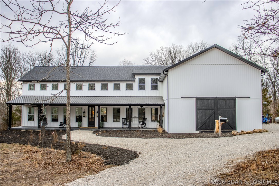 This 4 bedroom, 4.5 bathroom custom home on 5 acres offers 5,500 sq ft (m/l) of refined living space.Historic charm meets modern sophistication in the kitchen,highlighted by timber posts & a handcrafted lighting beam from a century-old barn.Custom cabinetry is paired with a fully integrated,panel-ready refrigerator that blends seamlessly with the cabinetry.A private prep kitchen includes a commercial ice maker,abundant storage,plus a second dishwasher and refrigerator.The main level primary spa-inspired en suite features a dual-entry walk-in shower a wall of custom wardrobe cabinetry, a stackable washer & dryer & an LG Steam Closet.Upstairs are three additional bedrooms,each with a private full bath & walk-in closet,plus a laundry room. The loft overlooks the great room & offers space for a secondary family room.Additional features include dual HVAC systems, central vacuum, two 50-gallon water heaters, and a 24kW Generac generator.Set on 5 acres, the property offers privacy and frequent wildlife sightings including deer and turkey, while remaining a short drive to the West Gate of Fort Leonard Wood & within the Waynesville School District.