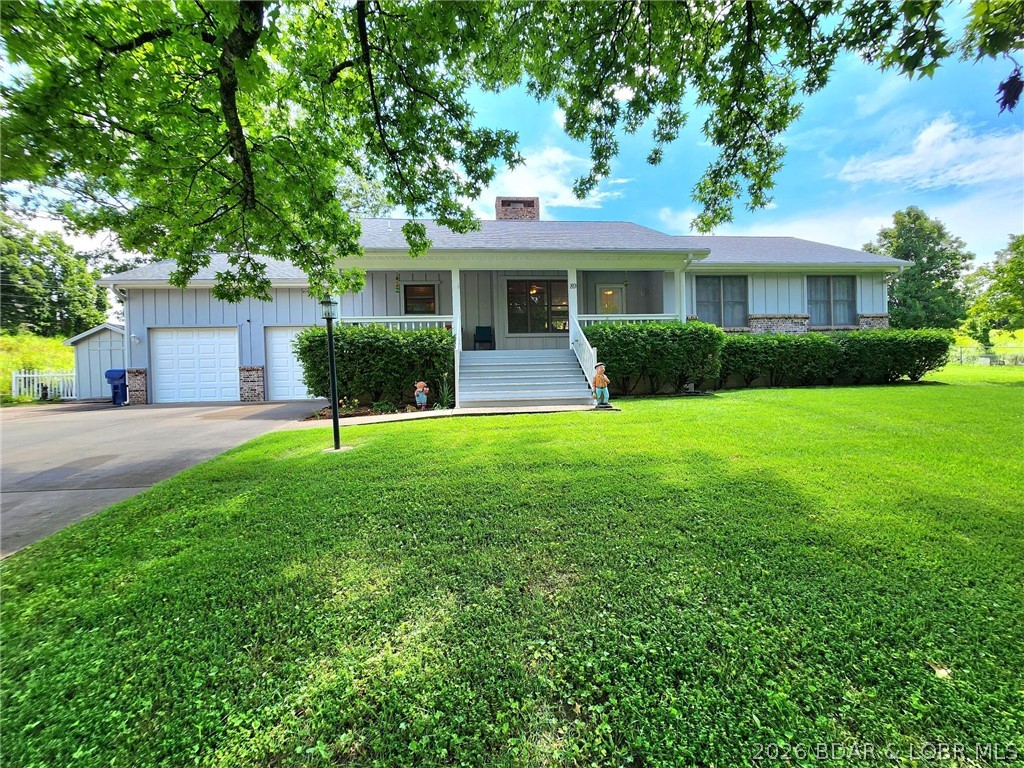 Motivated Seller-has moved & is Open to Reasonable Offers. In Camdenton, Move-in-Ready Hm w/ GORGEOUS fenced in, INGROUND Saltwater POOL & Lrg Pool Patio/Garden Areas. 3 Blocks to Town Sq. VERY NICE, Well Maintained Neighborhood. Easy Access 2-5 Mins to Schools & Shop’g. Pride-of-Ownership displayed in this Impressive, Meticulously Well Maintained Hm, Pool & Yards. 3Bed, 2Full Bath, 1,503 sqft, 1 Level Liv’g w/LvRm, DinRm, Spacious Kitch, Laundry/Mud/Pantry Rm & Gas Brick “See-Thru” Fireplace. Spacious 24x24 Attch 2 Car Garg w/ Abundance of Stor'g & Electric Chair Lift into hm for Physically Challenged. Whole Hm H20 Filter System, H20 Softener. Inground Yard Irrigation/Sprinkler System. Gorgeous Wood Floors, Newer Custom Built Wood Cabinets in LivRm, Lrg Peaceful Covered Front Porch to Enjoy the Landscaped Yards & Seasonal Creek @ Property Line. The POOL 3’ & 6’ Deep will WOW You!! When in Season, Pool Area is SIMPLY STUNNING w/ Perennial Flower & Veggie Beds, Grassy Areas, and Lots & Lots of Concrete Pool Patio Area which is Wired for HOT TUB. Most Pool Components Recently Replaced. Security/Monitoring System for Pool & Home Stays.  Must See EXTRA FEATURE SHEET for more DETAILS.