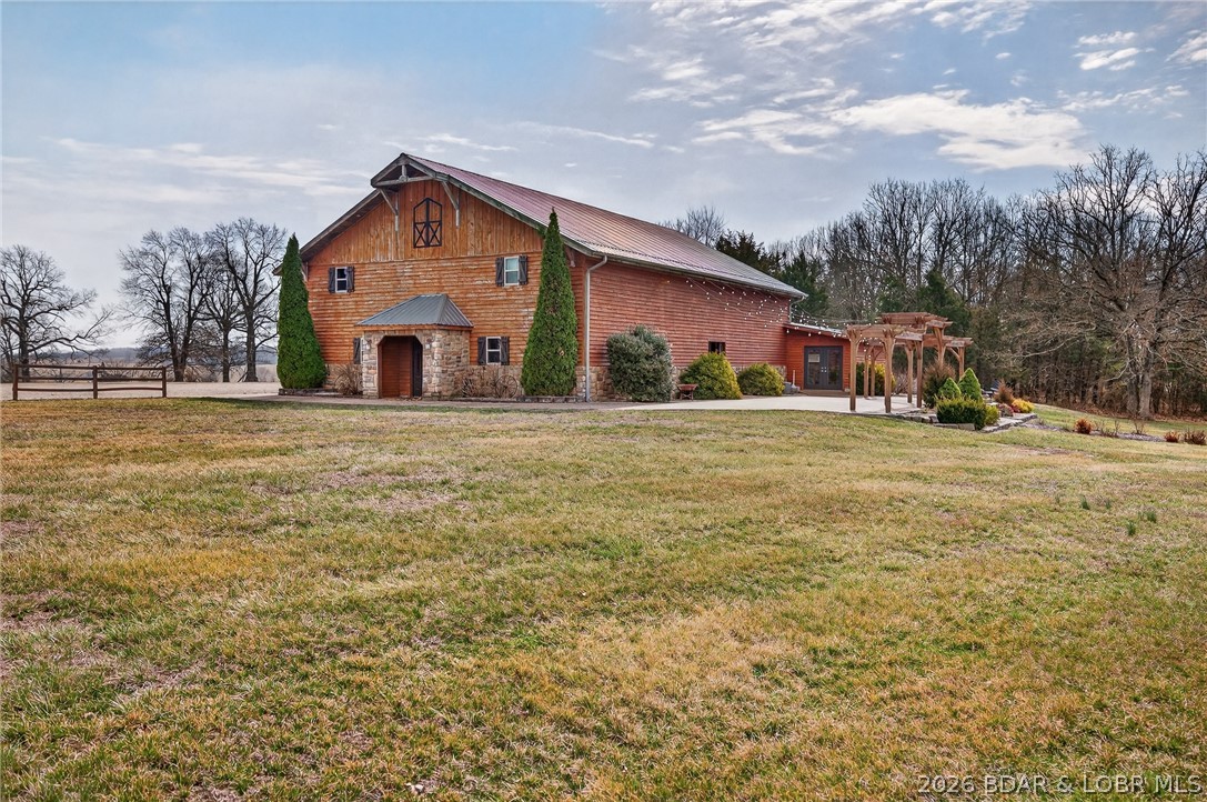 BACK ON THE MARKET DUE TO NO FAULT OF THE SELLER!! This 5,300 sq ft two-story wedding barn and event venue sits on 5 scenic acres in a peaceful rural country setting and is designed to accommodate up to 200 guests with seating on both the upper and lower levels. The property features separate bridesmaids’ and grooms’ dressing rooms, three bathrooms, ample storage, and a dedicated goodie barn for décor and event items, along with abundant on-site parking. An outdoor patio provides flexible space for gatherings and ceremonies, complemented by a dedicated outdoor ceremony area with arbor and benches, allowing for both indoor and outdoor events. With its versatile layout and turnkey infrastructure, this property is ideal for weddings, receptions, corporate events, private parties, and can easily function as a multi-purpose event venue with strong income potential.