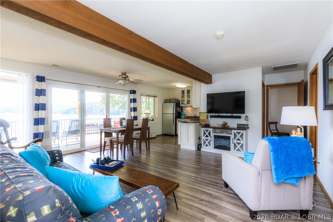 Experience the best of lakefront living in this beautifully updated 3-bedroom, 1-bath condo located in a private four-plex on 100 ft of shoreline. Breathtaking channel views and a level walk from the parking area to the front door, this property combines convenience, comfort, and unbeatable waterfront setting. Recent updates include spacious 12' x 25' lakeside deck, new 9' sliding glass door, flooring, roof, and septic system. The bright and inviting living area is filled with natural light and showcases stunning lake views, creating the perfect space to relax or entertain. Included with the property is a 10' x 28' boat slip equipped with a 5,000 lb boat lift, making it easy to access the water whenever you choose. The community dock features a swim platform and fish cleaning station for added enjoyment and convenience. Gather around the shared lakeside fire pit or unwind on the martini deck while taking in spectacular sunsets over the lake. Whether you're searching for a full-time residence, weekend retreat, or investment property, this move-in-ready condo offers an exceptional opportunity to enjoy the Lake lifestyle with numerous recent improvements and outstanding amenities.