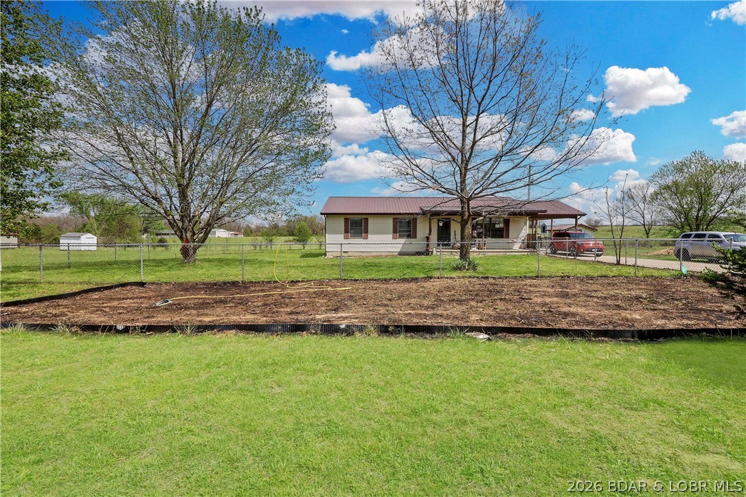 Stop renting and start owning!! Come see this 3BR/1.5BA ranch-style home in a serene country setting, but still not far from town. Functional main-level living featuring a primary bedroom with a half bath, dining area, living-room, hall bath, 2 more bedrooms and a generous laundry room. New luxury vinyl flooring has been installed throughout the home & no worries a new septic has also been installed.  Enjoy the massive, level lot with a fenced in front & back yard perfect for your pets or small children. Carport that could easily be converted into a garage & great parking. The existing carport offers a fantastic opportunity for a garage conversion to add instant equity. Plenty of room for your own garden & storage shed in the back for all your gardening tools. Perfect for first-time buyers, retirement, or investors. This affordable home won't last long—book your showing today!
