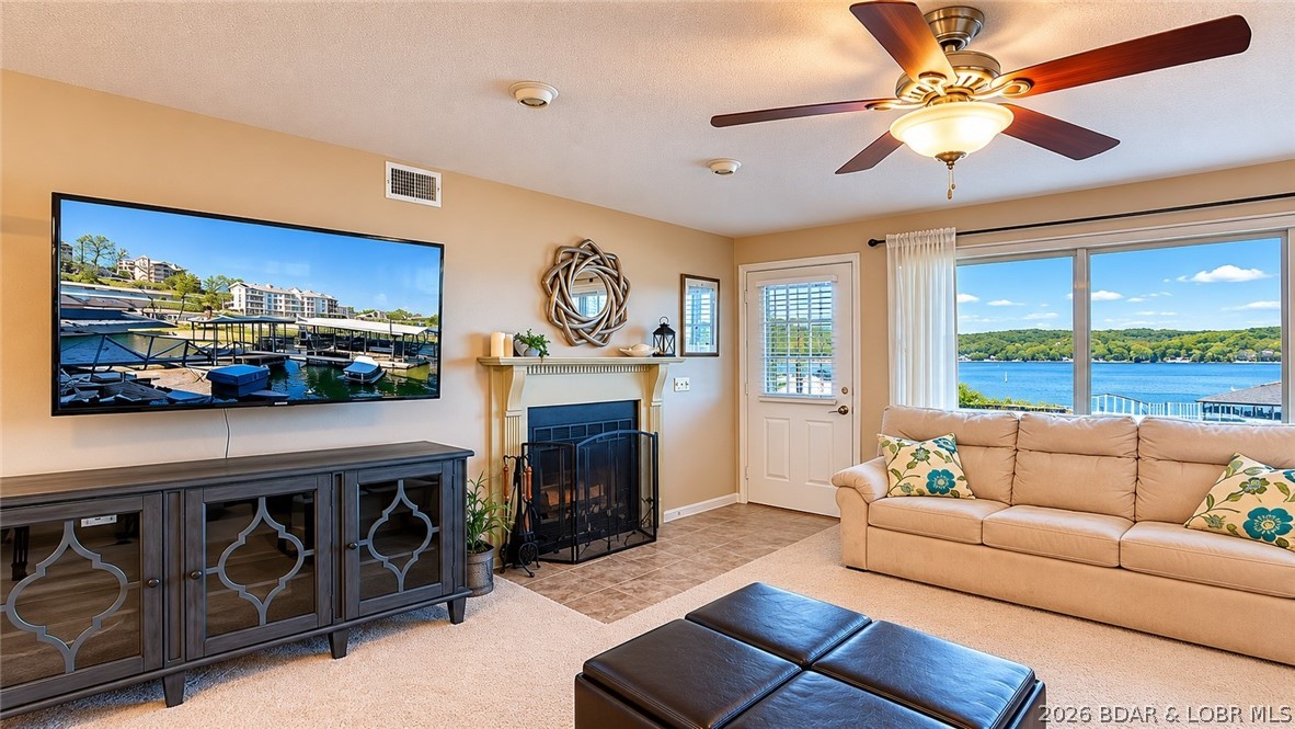 Main channel views, vacation rental eligibility, and a covered boat slip make this 2-bed, 2-bath lakefront condo at Breakwater Bay Club a standout at Lake of the Ozarks. Located at the 22-mile marker in Osage Beach, this well-maintained unit offers 1,125 sq ft, direct lake access, and stunning open water views. Pride of ownership is evident throughout, with a nicely updated primary bathroom and a clean, move-in-ready feel. The screened-in deck expands your living space outdoors, giving you a front-row seat to lake activity while keeping the bugs out. Easy access with just a few steps from covered parking to the front door adds to the appeal. The 10x28 covered slip with 8,000 lb lift sits just steps from the unit, ideal for a pontoon or deck boat. A new dock is coming in May with a larger 12x32 slip (A1). Breakwater Bay Club amenities include a pool, clubhouse, playground, and tennis courts. Nightly rentals allowed—perfect for investment or personal use!