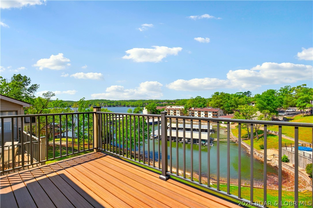 123 Barba Le Lane #3A in Lake Ozark at Robinwood Condos offers a warm and inviting way to enjoy lake life. This top floor, end unit condo features 2 bedrooms, 2 baths, and a bright open layout with vaulted ceilings, a beautiful stone fireplace, and easy access to the deck for relaxing cove and main channel views. Recent updates include new flooring, fresh paint, and updated window and sliding door glass, giving the space a clean and refreshed feel. With a community pool, clubhouse, tennis courts, community dock, 12x28 slip with hoist, and PWC lift, this property is ready for full-time living, weekend escapes, or rental potential.