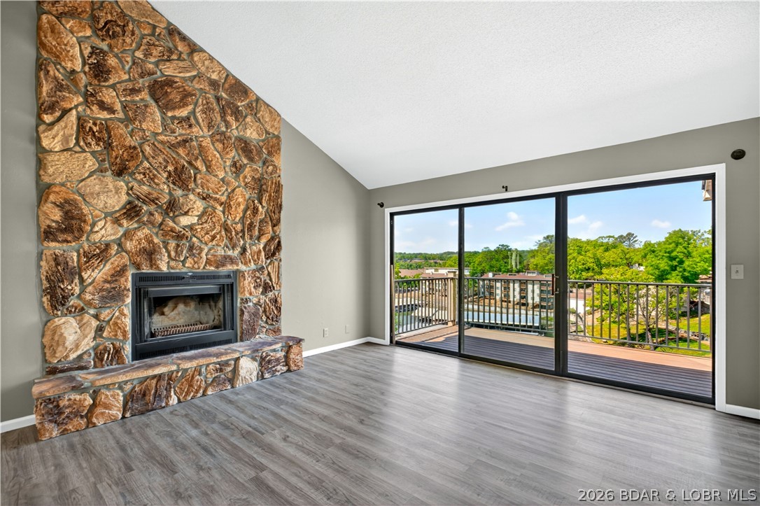 123 Barba Le Lane #3A in Lake Ozark at Robinwood Condos offers a warm and inviting way to enjoy lake life. This top floor, end unit condo features 2 bedrooms, 2 baths, and a bright open layout with vaulted ceilings, a beautiful stone fireplace, and easy access to the deck for relaxing cove and main channel views. Recent updates include new flooring, fresh paint, and updated window and sliding door glass, giving the space a clean and refreshed feel. With a community pool, clubhouse, tennis courts, community dock, 12x28 slip with hoist, and PWC lift, this property is ready for full-time living, weekend escapes, or rental potential.