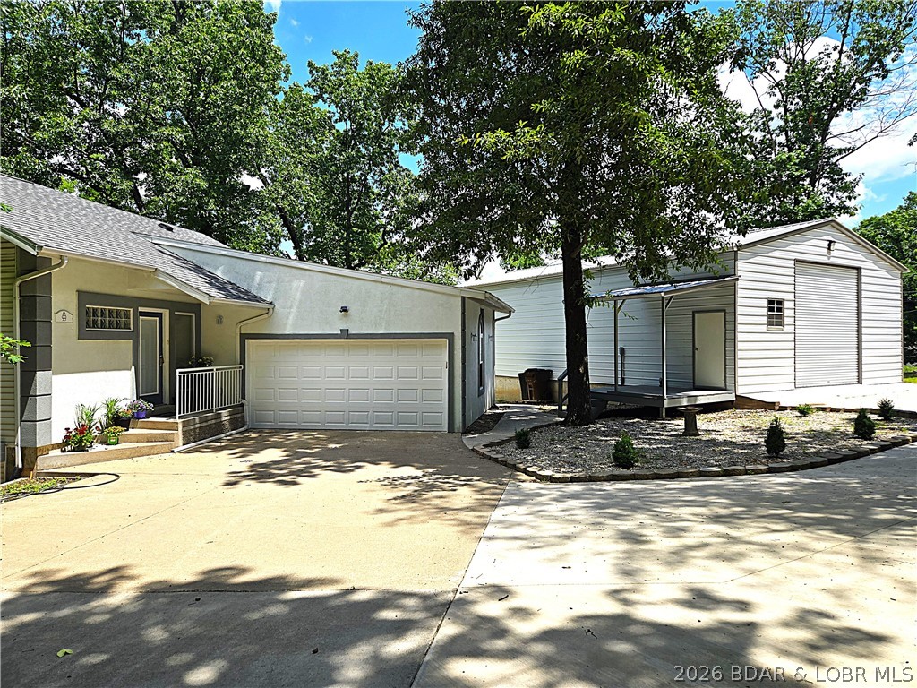 Welcome to your ultimate lake retreat! This stunning 3-bedroom, 2-bathroom home sits on a spacious 1.17-acre lot offering a beautiful cove view. The interior features an open kitchen and dining area, perfectly complemented by a cozy, sunken living room with a striking stone fireplace. Both full bathrooms have been tastefully updated with custom tile walk-in showers.
Outside, maximize your lake living with two large decks off home and a private firepit area off the shop. In addition to the 2-car attached garage, hobbyists and mechanics will love the massive 30x50 insulated shop, complete with a car lift and a 16-foot door.
Included also is 11x28 slip in a shared dock with a double PWC lift.  Don't miss out on this one!