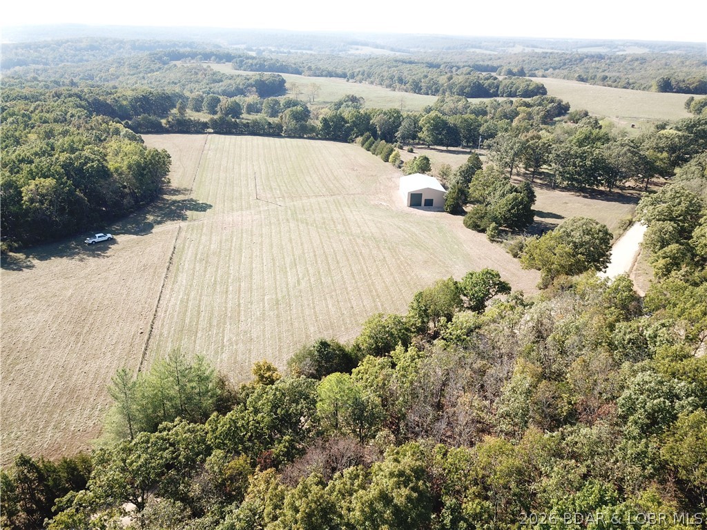 Bring your barndominium dreams or business plans to life in Crocker, MO! This stunning, nearly new 40x60 metal building sits perfectly on 5.44 gently rolling acres in Pulaski County, with 4.73 acres already fully fenced for livestock, pets, or extra security (p. 1). Built on a heavy-duty concrete slab, the structure features impressive 14-foot eave walls, an 18-foot center peak apex, and robust 200-amp electrical service. Save massive development costs with a brand-new well and a brand-new septic system already in place. Vehicle access is a breeze with two garage doors: a standard 9x8 door and a massive 12x14 door designed specifically for RVs, boats, or heavy equipment. Whether you want to finish out a custom living space or utilize it as the ultimate hobby and utility building, this rare gem is ready for you. Schedule your tour today
