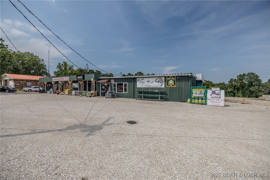 ¼ Mile to Camdenton & 1 Min. to New Highway 5 Exit Ramp. GREAT LOCATION.  Well maintained approx. 11,491 SqFt Metal Building on 2.6 Acres with 200 ft of Highway Frontage. Just Outside the City Limits, Across the Road from a Catholic Church. This Includes PROPERTY/BUILDING ONLY. The Building is well maintained & is in good condition & consists of Approx 3,491 SqFt of Show Room Retail/Office Spaces, Approx. 1,900 Sq Ft Large Storage Areas, 8,000 Sq Ft Warehouse w/ 2, 14 x 12 drive-thru GARAGE DOORS on each end. Expansive & Spacious Landfill Area (Which more than ½ has been filled) offering an abundance of additional parking for vehicles, large equipment & room for expansion of the Building or to add structures. This property is surrounded by Numerous Successful Neighboring Businesses. Individual Showrooms for Equipment Dealership, Livestock Feed & Pet Supplies, Yard & Garden Décor & Supplies, Live Bait & Tackle, Liquor Sales. Must See EXTRA FEATURE SHEET in attachments for numerous DETAILS. This purchase price DOES NOT include the Business, Equipment, Inventory, Supplies, etc. Seller's have recently retired and the Business is no longer in operation.