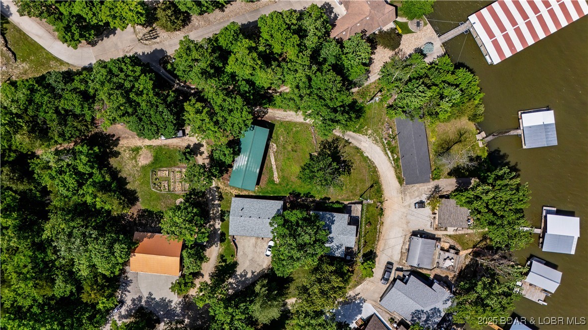 Prime lake view vacant lot located at the 36 Mile Marker in Sunrise Beach, offering stunning views of Lake of
the Ozarks. This build-ready property is perfect for your dream home or vacation getaway. Enjoy peaceful
surroundings with easy access to nearby marinas, restaurants, and lake activities. This property also has access
to a boat ramp directly in front of your property making it seamless to get out on the water. Don’t miss this rare
opportunity to own a piece of paradise and build to suite your needs.