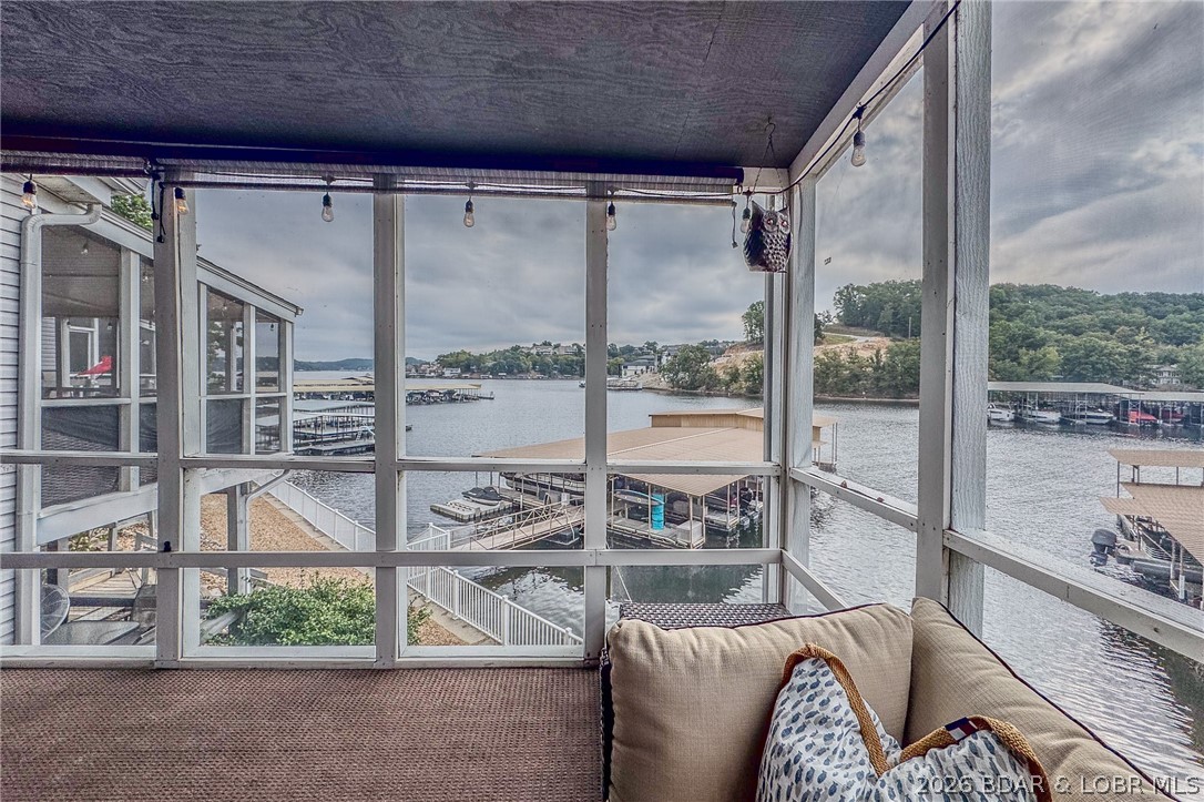 Welcome to 14 Bentwood Dr at the 3 Mile Marker of the Lake of the Ozarks. Step inside this beautifully updated, completely turn-key 4-bedroom, 3-bath home and you’ll immediately feel how thoughtfully it lives. The main level boasts an updated kitchen that flows effortlessly into the living area. The screened-in deck becomes your favorite spot gathering with friends as the sun sets.
The primary suite offers comfort and privacy on the main level, while upstairs you’ll find two bedrooms and a full bath. Downstairs, a second living area creates space to spread out, complete with a fourth bedroom and full bath. Open the door to the walk-out deck and follow the steps down to the dock. The community dock on Dock E features two slips, a swim platform, and wet steps, making it easy to slip into the water on warm afternoons. Tucked into a protected, no-wake cove, the setting is calm, swimmable, and ideal for relaxing days on the lake. With access to the pool, boat ramp, and beautifully maintained grounds, life here feels refreshingly simple.
If you’ve been waiting for a place where you can truly unwind and just enjoy the view — this is it. Come see it for yourself.