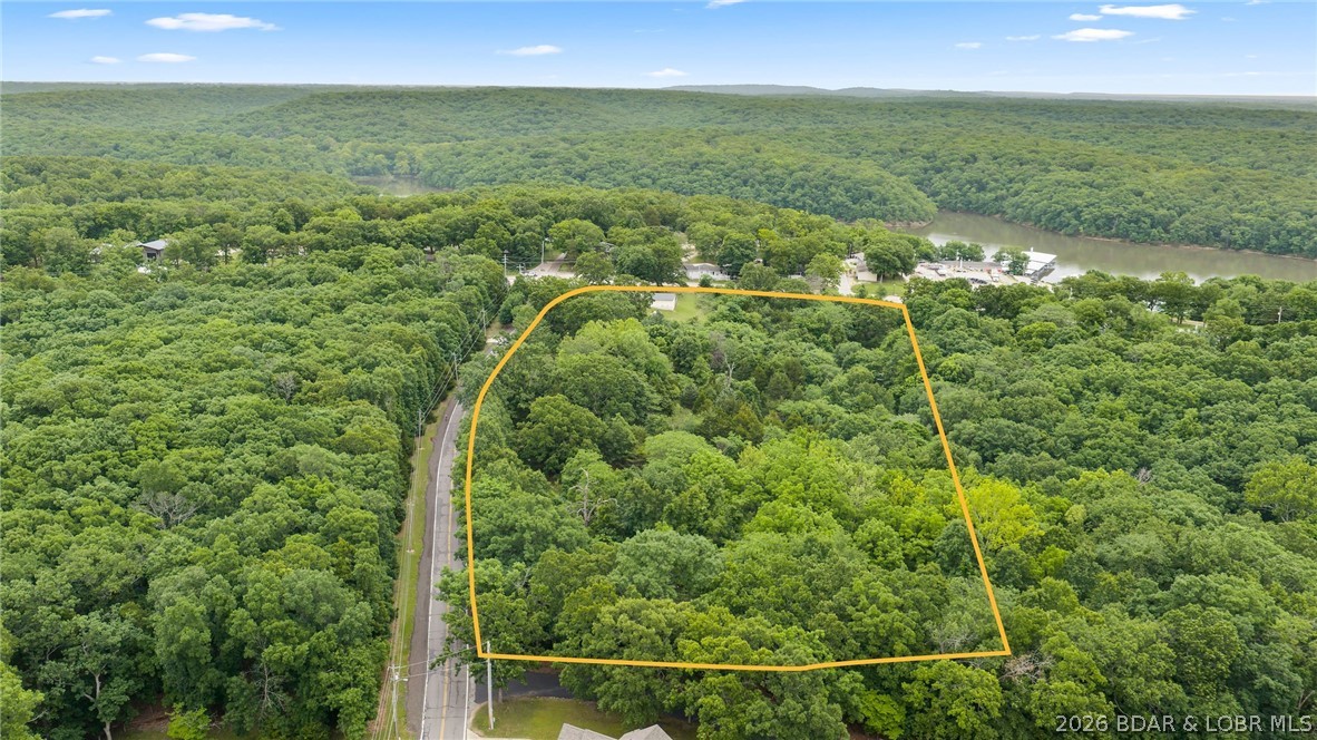 7.8 +/- wooded acres in the heart of Osage Beach with city sewer available! Extremely rare opportunity to find acreage of this size zoned agricultural within Osage Beach city limits. Prime development or private estate opportunity located just minutes from Lake Regional Hospital, shopping, restaurants, entertainment, and area schools. Beautiful wooded acreage offers privacy and endless potential. Additional adjoining parcel available featuring a 3 bedroom, 2 bath home. Excellent location with easy access to all the conveniences of town while maintaining a peaceful setting. Rare opportunity to own large acreage in one of the Lake area’s most desirable locations!