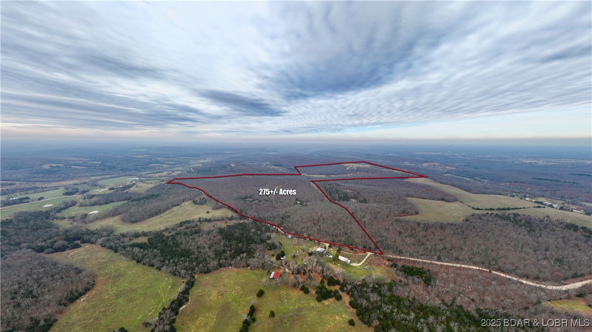 Calling all outdoor enthusiasts, hunters, cattle ranchers & dream-home visionaries! This remarkable 275± acre property offers some of the most captivating scenery in the region. Featuring nine fresh water ponds, a running water creek, mature harvest-ready timber & quality trails throughout, this land is a true natural haven. The property is gated, fully fenced & cross-fenced, making it ideal for livestock, recreational use or development of a private estate. A well is already in place & access to electric & phone is available. For hunters, this is truly prime ground with some of the largest deer in the Ozarks. The acreage offers exceptional Deer & Turkey habitat, complete with strategically placed deer stand & feeders. Wildlife thrives here, supported by abundant water sources & varied terrain. Whether you’re seeking unmatched hunting land, a working farm or the perfect location to build your dream home with panoramic Ozark views, this property delivers. Best of all, it’s located less than 30 minutes from Osage Beach, offering both seclusion & convenience. Properties of this size, quality & natural beauty rarely come to market—don’t miss this opportunity.