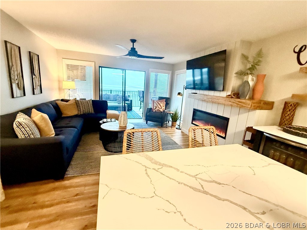 LUXURY LAKEFRONT WALK-IN LEVEL 12x28 SLIP + NEXT TO POINT POOL! Luxuriously updated 2-bed/2-bath condo offers easy access only 2 steps up from parking. Upgrades include All-New Custom Kitchen Cabinets & Island w/Quartz Countertops, Stainless Frigidaire Appliances, Built-In Wine Cabinet, LVP Flooring, Stunning Shiplap Fireplace w/Custom Shelving, New TV & Gas Grill on Deck. New Toilets, Bath Vanity w/Quartz & LED Anti-Fog Mirror. Designer-selected modern furnishings & décor create a stylish, move-in-ready lake retreat. Main channel views from the spacious corner wraparound deck—perfect for watching the sunrise & taking in the lake lifestyle. Ideally located one building from lakefront pool, one of the most desirable locations in the complex. The 12x28 boat slip is conveniently located next to the building, PWC slip is available for an additional $5,000. Additional 2023 improvements include new HVAC system, new windows, wash/dryer. HOA amenities include newly remodeled heated indoor pool/hot tub (2025), lakefront pool, swim dock, concrete boat ramp, playground, & new pickleball courts. This property checks all the boxes with Luxury, Lakefront, Next to Pool, and minimal steps.