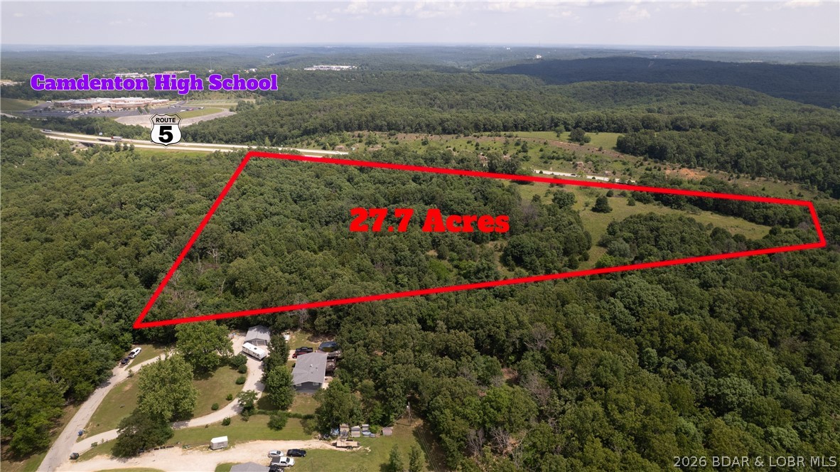 62.9 acres with over 3,300 feet of frontage along State Highway 5 in Camdenton! This versatile property offers a unique combination of development potential and recreational appeal. Zoned R-1, the land features a mix of open pasture and mature timber, creating multiple possibilities for residential development, a private estate, or recreational retreat. A scenic pond, established ATV trails throughout the property, abundant wildlife, and varied terrain make it ideal for hunting, camping, trail riding, and outdoor enjoyment.

The extensive highway frontage provides excellent visibility, while the size and layout offer flexibility for future residential lots or a planned housing development. Whether you're a developer seeking your next project, an investor looking for land with upside potential, or an outdoor enthusiast wanting a private getaway, this property delivers a rare opportunity in the heart of the Lake area. Conveniently located near Camdenton amenities, schools, shopping, and Lake of the Ozarks attractions.