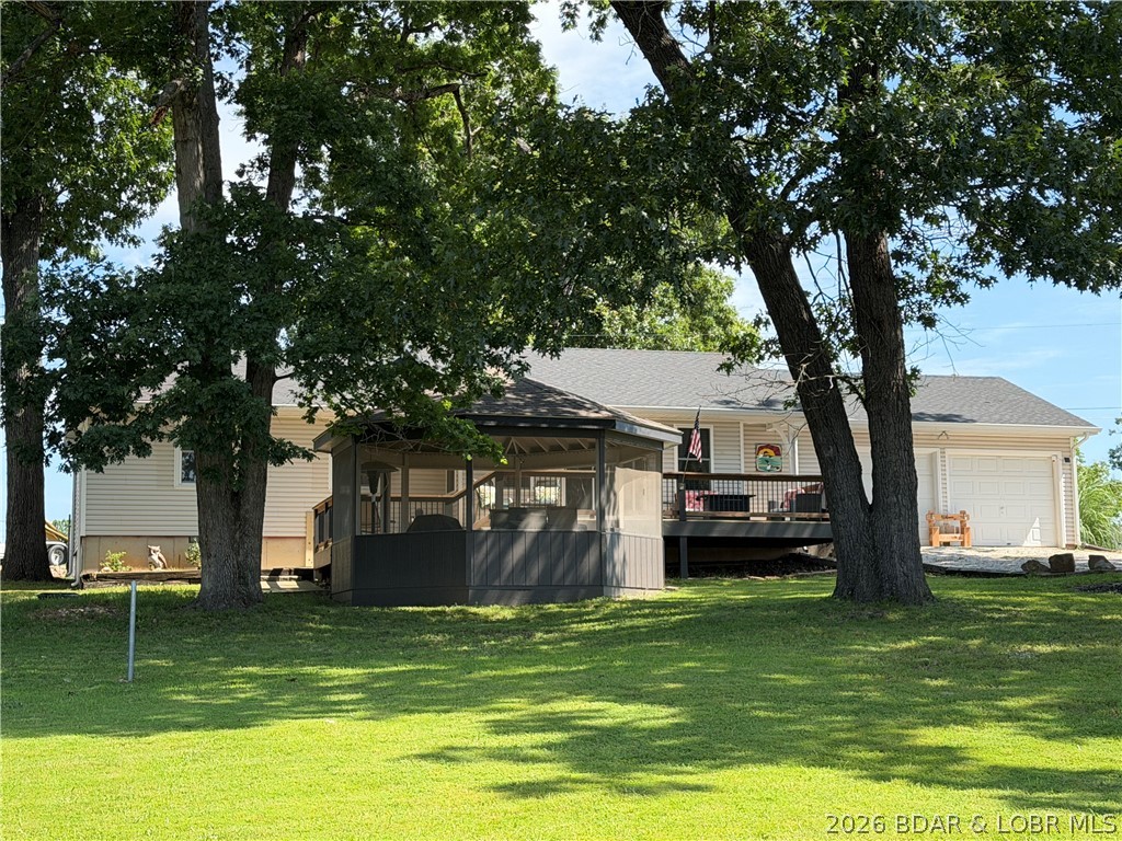 This beautifully updated 2-bedroom, 2½-bath home offers an open-concept living, dining, and kitchen area in a quiet, low-traffic subdivision at the desirable Lake of the Ozarks 38-mile marker. Enjoy rare year-round main channel views, a spacious setting with plenty of privacy, and paved roads all the way to the front door while remaining just minutes from groceries, shopping, restaurants, and the movie theater. Recent improvements include a new roof (2022), beautiful luxury vinyl plank flooring and new bedroom carpet (2023), a remodeled primary bath with updated plumbing throughout (2023), new countertops (2024), and new Pella easy-access windows, screens, and gutters (2025). Outdoor living is exceptional with a large screened gazebo featuring electricity and a ceiling fan, a huge updated shaded deck, an expansive gently sloping front yard, and a fenced backyard that's perfect for pets or deer-free gardening. The seller currently rents a nearby boat slip, adding to the lake lifestyle. The home was also offered as a VRBO beginning in August 2025 and received eight 5-star guest reviews through November, providing excellent short-term rental income potential.