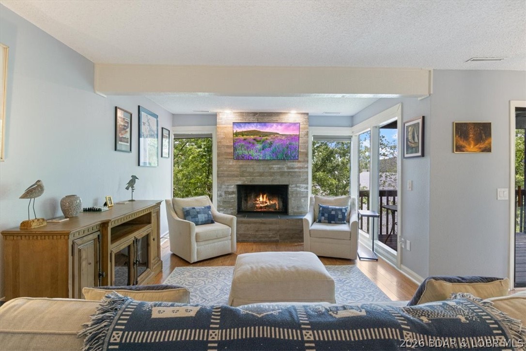 DEEP WATER and GREAT FISHING YEAR ROUND! Enjoy lakefront living in this charming, well-established complex with only 3 units in this building—offering privacy and a peaceful setting. This unit features wood-burning fireplaces in both the living room and master bedroom, an open-concept kitchen, dining, and living area, built-in entertainment center, custom cabinetry, pantry, quartz counters, stainless steal appliances, walk-in closet, and laundry/utility space. Take in stunning HUGE views of the sparkling water of the 29 MM of the Osage from not one, but two lakefront decks. A 12x32 boat slip concrete dock with jet ski lifts is included, located right in front of the unit for easy access to the water. The dock is for the owners in this building so it has the "private" feel. DEEP WATER is perfect for year round use and swimming/ fishing off the dock is allowed. Conveniently situated near top restaurants, shopping, and local attractions. Rentals must be a minimum of 6 months. This is GREAT way to enjoy the lake of the ozarks as a vacation getaway or a full time residence! Comes furnished and ready for fun! Don't wait schedule as showing today!
