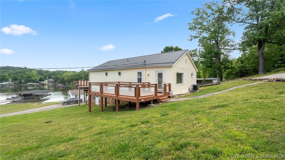 Move-in ready lakeview cabin offering 3 bedrooms, 2 baths, and desirable main level living in a close-knit waterfront community! Enjoy beautiful lake views and easy lake access with your own 10x24 slip in the community concrete dock. This charming home features a durable metal roof, warm cabin character, and a lower level with an attached 1-car garage for added convenience and storage. The community is developing a golf cart parking area and path, making it even easier to enjoy everything the neighborhood has to offer. HOA dues include road maintenance, sewer, water, and lawn care for low-maintenance living.
Located at the popular 8 MM in Buck Creek Cove near Shady Gators and Camden on the Lake, you’ll be just minutes from waterfront dining, entertainment, and all the excitement Lake of the Ozarks has to offer. From the road, you are right across from Bear Bottom Resort. This is a perfect investment opportunity whether you're looking add an additional nightly rental to your portfolio, or for incredible 2nd home living opportunities.  Call today to schedule your private showing!