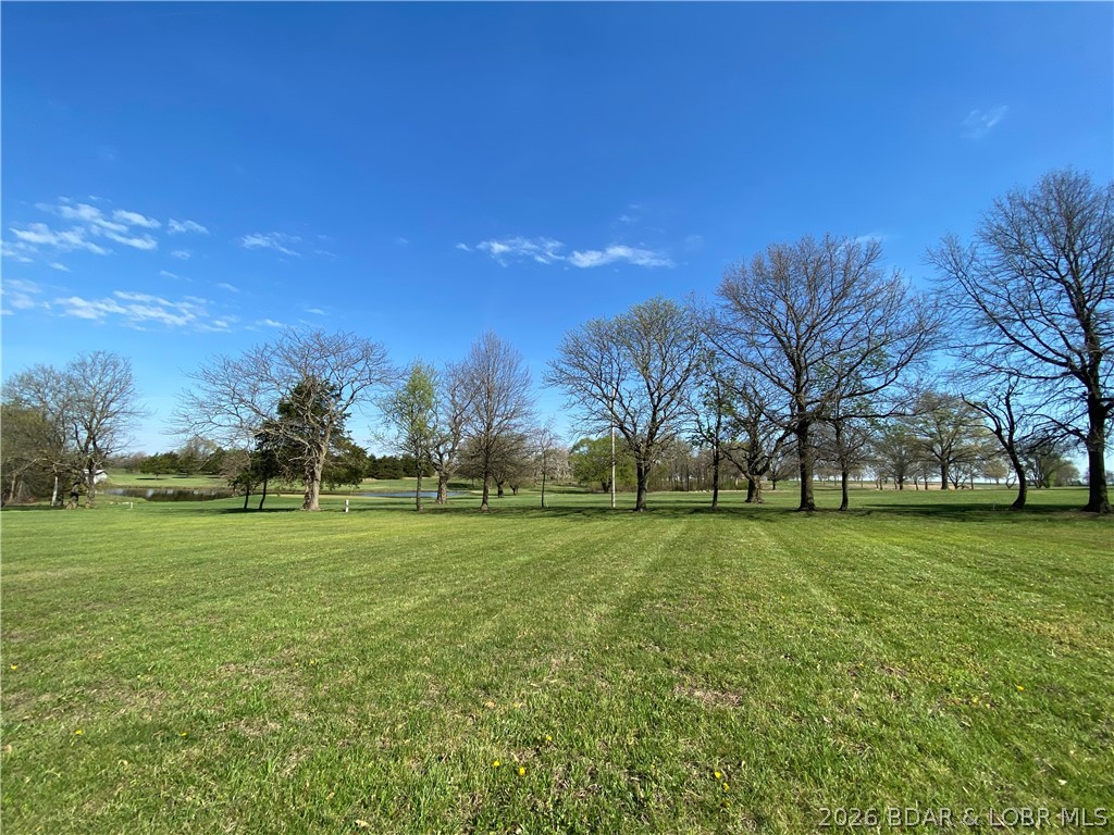 Build your dream home on this beautiful 0.75-acre lot located in a desirable subdivision and backing directly to the golf course. Enjoy peaceful views, a scenic backdrop, and the feeling of extra space behind your property. This lot offers a great opportunity to create the home and outdoor living area you have always wanted while being nestled in an established neighborhood. Maybe you've been thinking it's time to retire or move off the Lake but you don't want to go too far, this could be your answer. The location combines community living with the beauty of the course right in your backyard. A rare chance to own a homesite with golf course views and plenty of room to bring your vision to life.