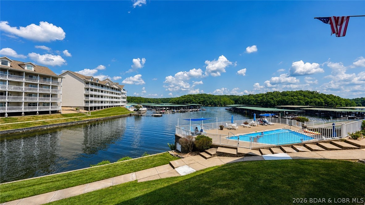 Waterfront condo  at Parkview Bay in Osage Beach, Missouri, at the 1 mile marker of the Grand Glaize arm on Lake of the Ozarks. This 1,047 square foot, 2 bedroom, 2 full bath unit includes a deeded 12x30 boat slip and a lakeside deck, with close proximity to one of the complex's 3 lakefront pools. A $10,000 furnishings allowance is included, and Parkview Bay allows vacation rentals, making this a turnkey option for a primary residence, second home, or short-term rental investment. Parkview Bay offers year-round deep water with cove protection and sits centrally between Party Cove, tubing coves, fishing coves, and anchoring coves in one direction, and minutes from Main Channel dining and entertainment including Dog Days, Backwater Jacks, and Red Head in the other. The complex features 3 lakefront pools, walking trails, and ample parking in the heart of Osage Beach, close to shopping, dining, and upcoming lake attractions including the future Oasis amusement park and a new Shoot-out location. Buyers searching for vacation-rental-eligible condos on Lake of the Ozarks with deep water access, a boat slip and resort-style amenities will find this Parkview Bay listing checks every box.