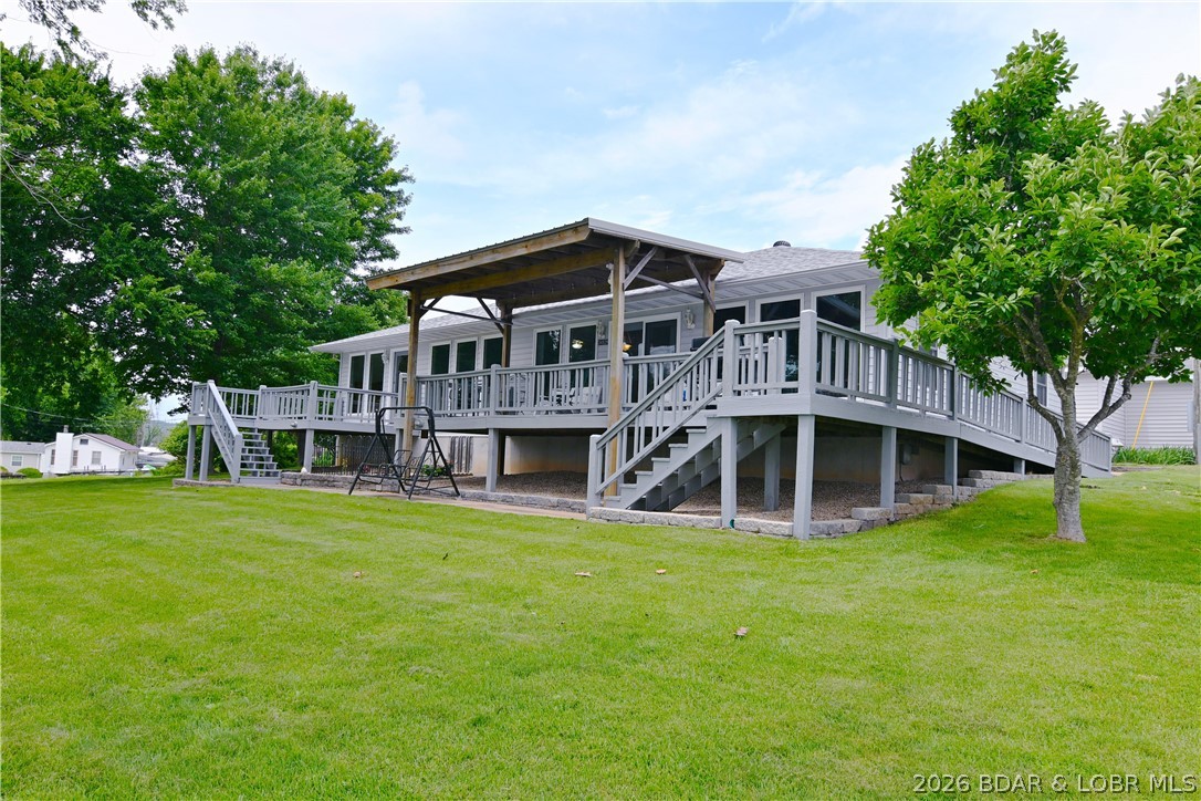 Lakefront opportunities like this don't come around often! Situated on the 60 MM of the Lake of the Ozarks, this well-maintained 4-bedroom, 2-bath ranch home offers approximately 1,800 square feet of comfortable living space and 200 feet of shoreline on a rare, flat lot. Enjoy exceptional waterfront amenities with 2 private docks featuring 3 boat slips and 2 PWC slips—all included with the property. Boat ramp is located directly next to the property. NO RESTRICTIONS OR HOA so feel free to park your RV or trailers on site without being hassled.

The home has seen numerous major updates, including a new roof (10/2024), new furnace (11/2025), new water softener (12/2025), and updated septic system with new lateral lines, providing peace of mind for years to come. Outside, you'll find incredible storage and workspace options with a 30x50 shop, detached 2-car garage, and additional carport. Best of all, there is NO HOA, meaning no dues, restrictions, or extra fees. Finding this much lake frontage, usable ground, parking, storage, and waterfront infrastructure in one package is extremely rare. Move-in ready and waiting for its next owner to enjoy everything the  lake has to offer!