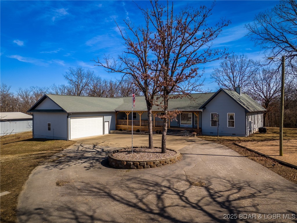 Recently remodeled & looking beautiful. Sitting on 27+ gorgeous acres just minutes from Laurie,  this home offers one level living with 4 bedrooms & 3 baths, a well equipped kitchen with an 5' x 8' island, living area, family room area & laundry all on the main level.  Upon entry, you are greeted with a beautiful stone wall with a 2 way fireplace shared with the roomy master bedroom. The master bath has double vanities, walk in shower & a separate tub.  The spacious family room with adjoining office area walks out to the large deck that is ramp accessible.  Adjoining the deck is a 14' x 29' 3 season room equipped with a hot tub.  The lower level has a wet bar & game room area, the 5th bedroom (non conforming), full bath & a bonus room with a built in safe.  The oversized attached garage has a 20'w x 10' h garage door AND an inside concrete ramp that leads to the lower level for moving larger items in/out conveniently.  ENERGY EFFICIENT!!  Check out the attached electric bills & info on the heating systems.  Included is a 50' x 60' Steel, insulated outbuilding, a playground area, beautiful stocked pond & stone fire pit.  This home offers too much to list. You need to check it out.