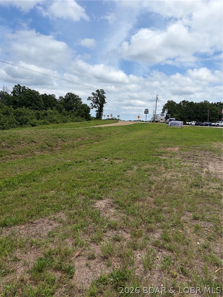 * Motivated Seller, Bring your best offer *  Rare opportunity to own just over 30 acres in a highly visible location just outside of Laurie, Missouri. Featuring approximately 500 feet of Highway 135 frontage along with additional access from Lake Trail Road, this property offers exceptional potential for commercial, residential, or investment use.  The land is primarily flat and usable along Highway 135, providing excellent building opportunities with easy access and outstanding visibility. As the property extends toward Lake Trail Road, the terrain gently slopes, adding character and flexibility for a variety of development plans.
Whether you're looking for a prime business location, future development property, storage facility site, retail space, multi-family project, or simply acreage with room to grow, this tract offers endless possibilities in a rapidly growing Lake of the Ozarks area.
Properties with this amount of highway frontage, multiple access points, and development potential are becoming increasingly difficult to find. Bring your ideas and make this exceptional property your next investment.Buildings are different parcels and not for sale. More photos on the way.