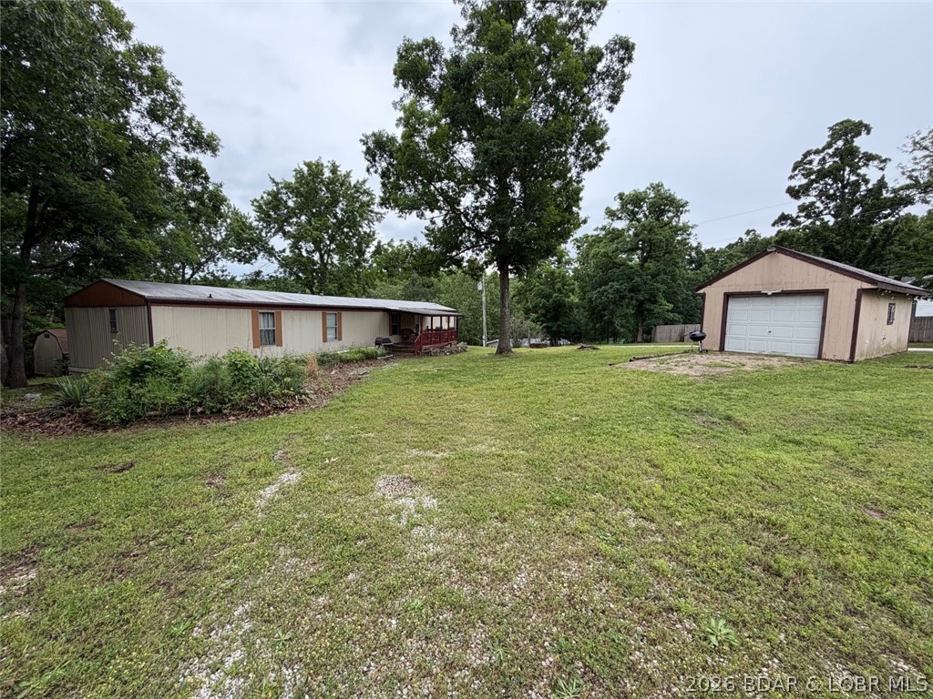 Affordable Lake Living Opportunity in the desirable Osage Highlands Subdivision! This 3 bedroom, 2 bath single wide home sits on a spacious corner lot with great parking and tons of potential for the right buyer. Features include a nice floorplan w/primary suite, open kitchen/living room, screened-in deck perfect for relaxing outdoors, covered front porch, 1-car detached garage, and additional storage shed for all your lake toys and tools. This fixer-upper is being sold as-is and is ready for your personal touch and updates. Enjoy the perks of lake life with community lake access, boat ramp, pavilion, and community trailer parking. Whether you're looking for a weekend getaway, investment opportunity, or full-time residence near the Lake of the Ozarks, this property offers endless possibilities at an affordable price! **Some areas of the flooring have had water damage from a broken pipe. Pipe was repaired**