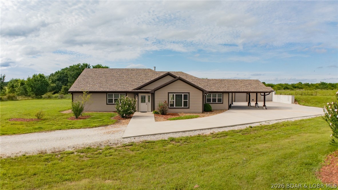 4-bedroom, 3.5-bath home situated on 10 beautiful acres. Featuring a convenient single-level layout with no stairs throughout, 2x6 exterior walls, R-19 cellulose foam insulation, a safe room, and a propane backup system. The living room features a stunning vaulted ceiling and opens to a cozy keeping room complete with a wood-burning stove, creating the perfect space to relax and gather with family and friends. Spacious primary suite is highlighted by an elegant tray ceiling and a well-appointed en-suite bath. A separate mother-in-law suite provides flexible living options for extended family, guests, or caregivers, offering both comfort and privacy. Outside, you’ll find both garage and carport parking, providing ample space for vehicles, equipment, and storage. The covered patio overlooks a fenced backyard, ideal for pets, children, or outdoor entertaining. Raised flower beds offer the perfect opportunity for gardening enthusiasts, while the new well and septic system provide added value and peace of mind. With quality construction, accessible design, multiple living spaces, and room to enjoy the outdoors, this exceptional property is a must-see!