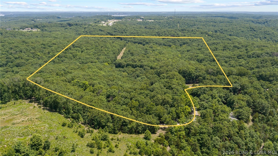 Two adjoining parcels totaling approximately 72 +/- wooded acres in the heart of Sunrise Beach, MO offer endless potential for development, recreation, or a private estate. Featuring mature timber, rolling terrain, and multiple ideal building sites, this beautiful acreage provides the perfect balance of seclusion and convenience with easy access to Lake of the Ozarks amenities, dining, and entertainment. Whether you are looking for a private retreat, family compound, or future investment opportunity, this rare offering presents countless possibilities in one of the lake area’s most desirable locations. An additional 3 +/- acre lakefront parcel with a home and direct waterfront access is also available separately, creating a unique opportunity to combine expansive acreage with lakefront living. See MLS number : 3587713 . Call for a private showing today!