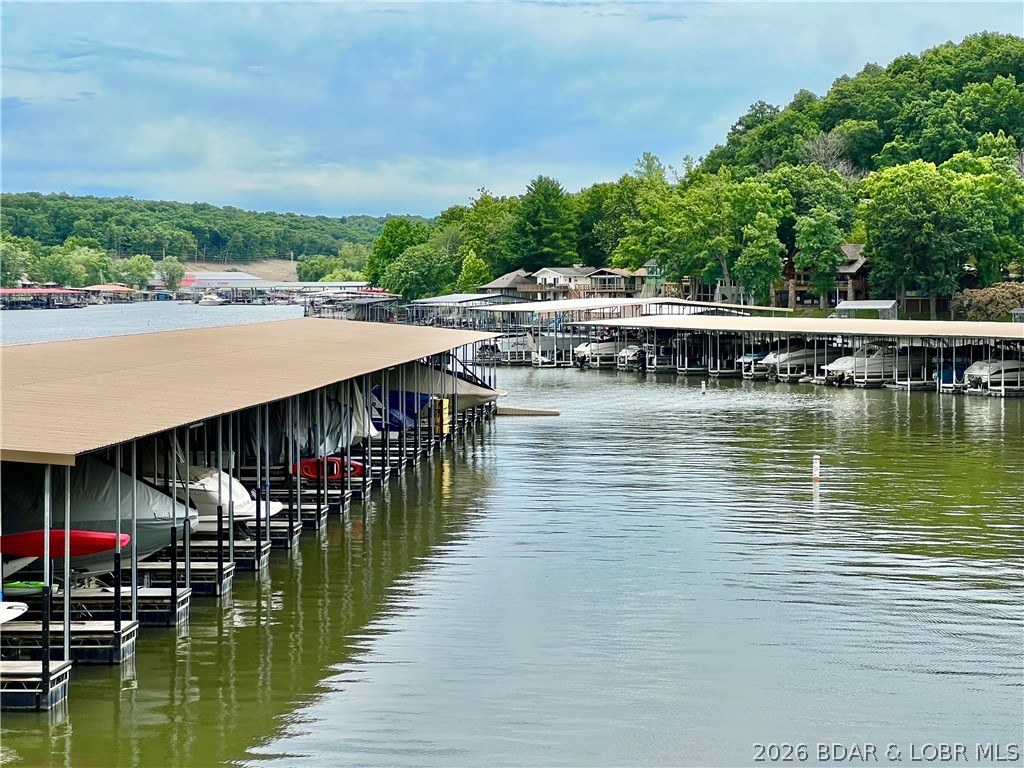 Seller Paid HOA Fees for 2026! A lakefront condo that is a perfect blend of comfort and convenience. This spacious 3-bedroom, 3-bathroom home is being sold turnkey, complete with furniture, fun decor, and a boat slip with a lift. With just three steps to your door and easy dock access, it's designed for easy living and almost no stairs. The condo boasts updated flooring and brand new carpet the bedrooms, adding to its charm. Two primary bedrooms suites is perfect for rentals and guests. Priced to sell, it offers fantastic value with a host of amenities: enjoy indoor and outdoor pools, a fully equipped exercise room, and a recreational space. You'll also find plenty of boat trailer parking, a clubhouse for gatherings, and indoor and outdoor tennis courts for year-round activity. Ideal for both full time living or weekenders, and is currently an income producing property! This well-rounded, adorable condo is ideal for anyone looking to enjoy a vibrant, active lifestyle on the water. Don't miss the chance to call this lakeside retreat your own.