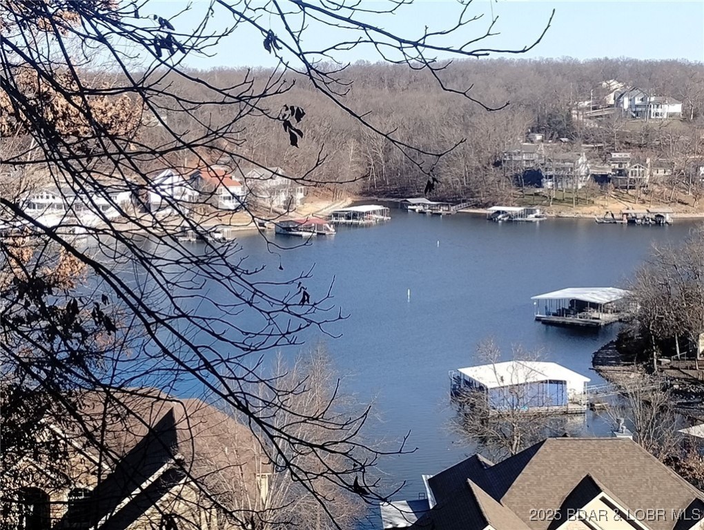 Check out this hard-to-find available lake view building site in Beacon Pointe. The site contains 19,063 square feet/.43 acres according to Miller County. This also includes a 12' x 32' boat slip in the Beacon Pointe community dock. Great neighborhood with a community pool, a clubhouse, a playground and super convenient location. The clubhouse has a covered patio with a fireplace, a game room/meeting room, a kitchenette and two half baths. Close to the Bagnell Dam Strip, Osage National Golf Course, a movie theater, shopping, restaurants, nightlife, convenience store and to Highway 54. There are building restrictions in Beacon Pointe that have helped keep the community as a sought after location. City streets, City water and City sewer are all a plus! Association fee is $750 per year. Boat slip fees are $1,600 per year. Boat slip assessment is for maintenance and repairs to dock and partially for paying for the wave break.