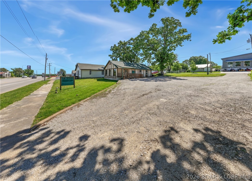 105 feet of US Hwy 54 frontage in Camdenton Mo., with up to 26,000 vehicles a day in peak season. Property includes 3 1/2 city lots, right in the mix with local shops, restaurants and banks. Currently used as a professional office, with several offices, but the possibilities are endless. Building has Hwy 54 access as well as access off of Chestnut St for customer access to your large parking lot and business. There is a second smaller parking area to the rear of the building off of Chestnut for employees and adds to the ease of access to come in or out of the business.