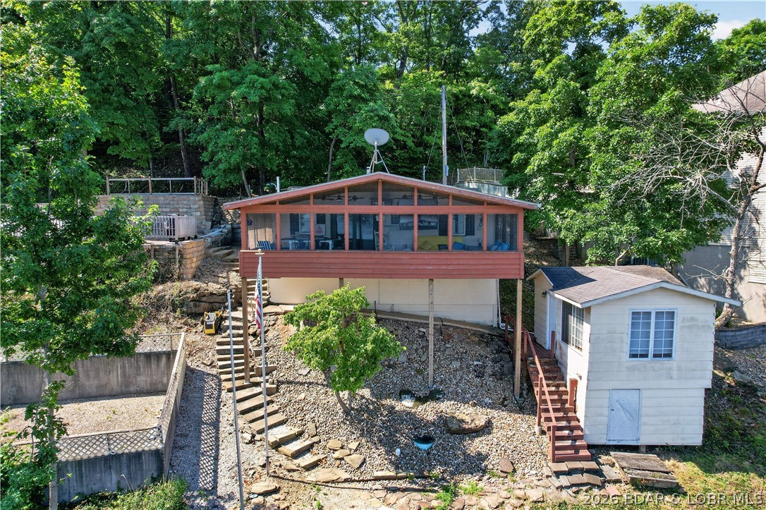 Looking to get your first lake cabin with deep water, killer lake views and minimal steps.  Here you go.  It's one of the last original cabins in this area.  2 bed/2 bath with an additional building that has a bedroom and 1/2 bath with storage beneath. (referred to as the "LOVE SHACK") Fish off the martini deck or just relax and enjoy the expansive views on the screened in porch. Property being sold Turnkey giving you immediate use. DNR engineered septic and shared well to top it off!