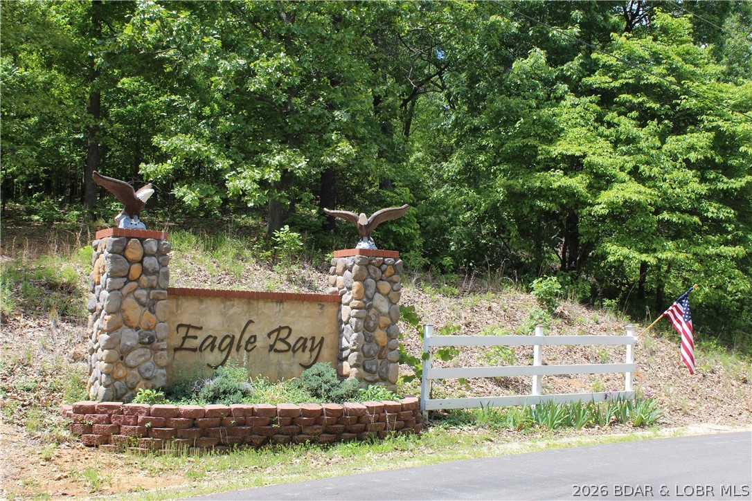 Looking for a build-ready lot overlooking Lake of the Ozarks, away from the hustle and bustle? This 2.21-acre lake view property on the quiet side of the Lake in the coveted Eagle Bay subdivision could be the perfect spot for your dream home. With electric service, community water, and community sewer already at the property, much of the groundwork is in place so you can start planning your ideal lake retreat. Enjoy gorgeous views of Proctor Cove at the 55MM of the Osage Arm, along with plenty of room to spread out and enjoy the peaceful surroundings. Conveniently located just minutes from restaurants, shopping, and everyday amenities in Laurie and Stover, this is an outstanding opportunity to own a beautiful piece of Lake of the Ozarks.