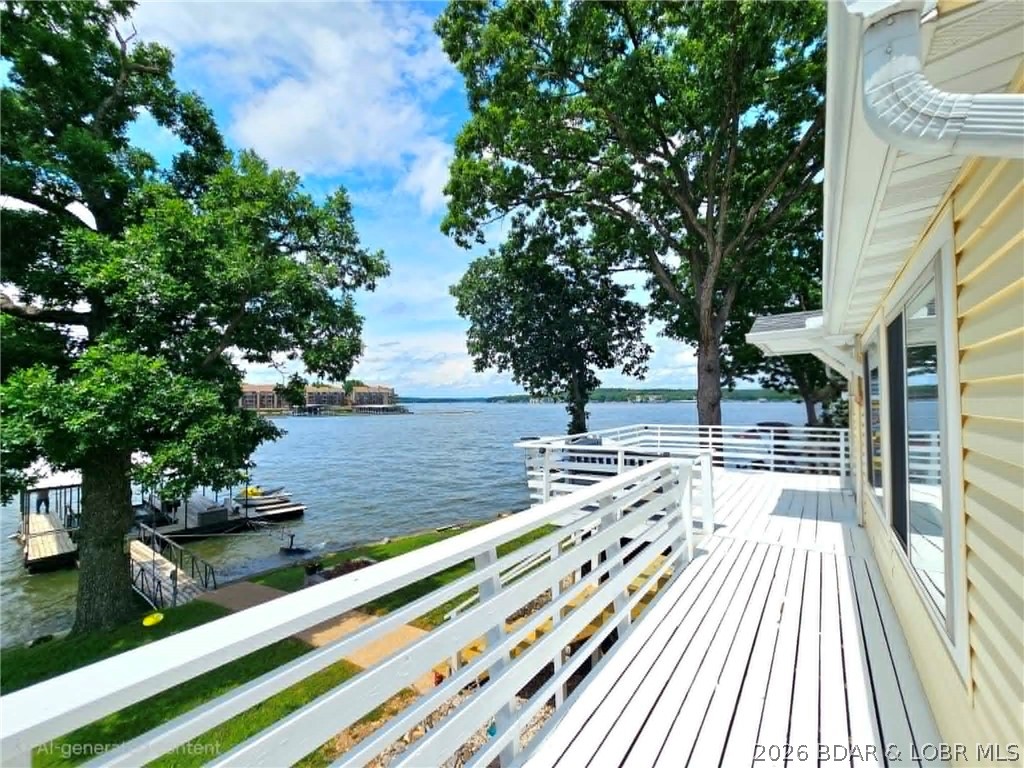 If you've been dreaming of owning a place at the Lake, this charming cabin is a must-see! Located at the coveted Osage 10 MM, this beautifully remodeled lakefront retreat offers stunning main channel views and all the comforts you need for relaxing weekends or year round enjoyment.  Remodeled in 2015, the home features an open and bright kitchen with granite countertops, stainless steel appliances, and beautiful wood flooring throughout the living areas. Large windows fill the cozy living room with natural light while showcasing breathtaking lake views. Step outside to the spacious deck, perfect for family cookouts, entertaining friends, or simply enjoying the peaceful waterfront setting. The VERY GENTLE lot provides easy access to the water and the private 1-well dock, complete with a boat lift and two PWC lifts. Located in a year-round deep-water cove, you'll enjoy excellent boating conditions no matter the season. Additional features include blacktop roads to the home, a private neighborhood boat ramp, and a convenient location that's easily accessible by both land and water. If you are looking for your own affordable slice of Lake of the Ozarks paradise, this could be it.