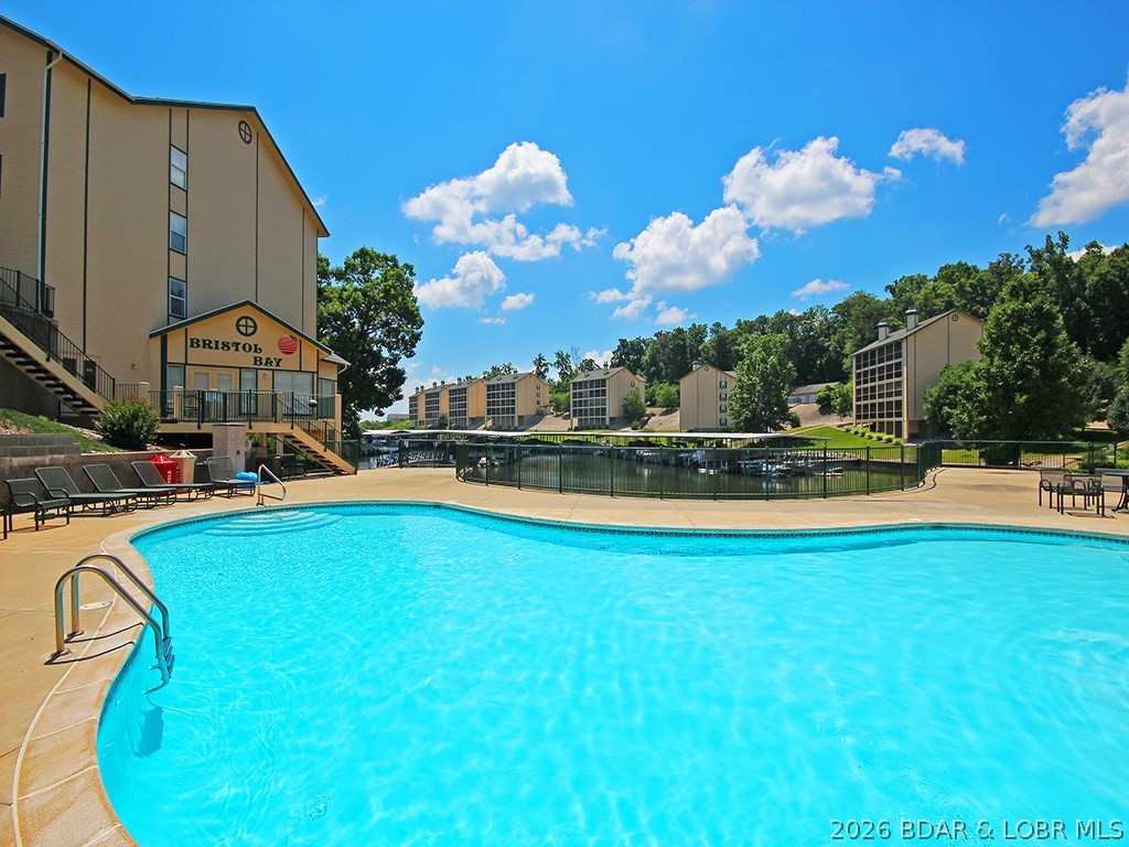 Amazing Lakefront Condo in Highly Desirable Bristol Bay! Welcome to this beautifully maintained condo, located in one of the finest complexes at the Lake of the Ozarks. Offering park-like tranquil atmosphere, this property provides the perfect blend of relaxation and convenience. Enjoy effortless access to your dock with NO STEPS. Inside, the condo boasts a spacious open floorplan, featuring luxury vinyl plank flooring, a cozy fireplace, a large walk-in closet, and a practical walk-in laundry room. Additional storage closets are conveniently located both on the deck and in front. The sought-after Horseshoe Bend location places you minutes away from The Cove and Ridge Golf Courses, as well as popular restaurants and bars at the 12-mile marker, making this condo the ultimate rental investment or personal retreat. Bristol Bay's exceptional landscaping and meticulously maintained grounds provide a calm and welcoming vibe for all. Included is a 12x30 slip with an 8000 lb boat lift and 2 PWC slips with lifts. 2023 rental revenue: $15,474.00 | 2024 rental revenue: $12,302.00. If you're ready to own your piece of paradise at Lake of the Ozarks, this is the property you've been waiting for!
