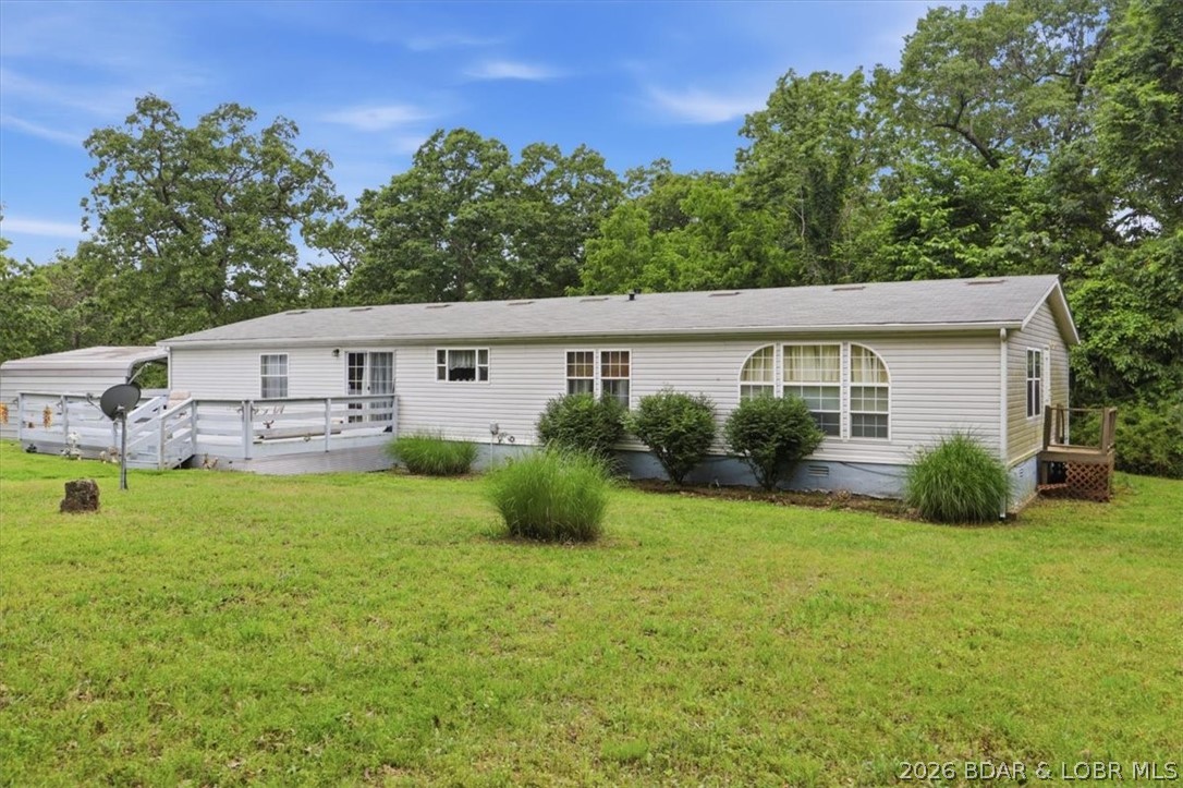 Escape to the perfect balance of privacy and convenience with this spacious 4-bedroom, 2-bath home situated just outside of Camdenton. Offering 2,356 square feet of comfortable living space, this well-maintained manufactured home feels more like a modular home and lives like a traditional ranch-style residence with an open, functional layout and easy one-level living. The property includes three lots totaling 6.06 acres, with a survey already on file and the acreage being separated from the original parcel. Recent updates provide peace of mind, including a new roof, gutters, gutter guards, and downspouts in 2022, along with a new HVAC system installed in 2023. Set on a solid block foundation with a dry crawl space, this home offers both durability and practicality. Enjoy plenty of room for outdoor activities, gardening, recreation, or simply taking in the peaceful surroundings. Located just minutes from Camdenton schools, shopping, dining, and everyday conveniences, you'll appreciate the privacy of country living without sacrificing accessibility. If you're looking for acreage, updates, and room to spread out in the Lake of the Ozarks area, this property deserves a closer look.