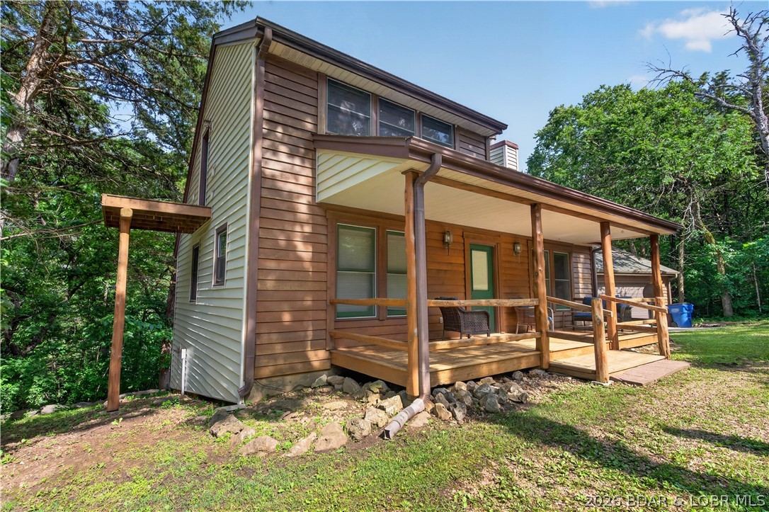 Escape to the tranquility of Truman Lake with this charming 2-bed, 2-bath, 1.5-story home situated on 3 +/- acres. Offering over 1,100 finished square feet, this property captures the perfect log cabin atmosphere and is ideal as a full-time residence or weekend retreat. The spacious living room features a beautiful stone fireplace, creating a warm and inviting gathering space. A generously sized kitchen provides ample room for cooking and entertaining, while the comfortable bedrooms offer plenty of space to relax. Outside, you'll find a detached 2-car garage, a convenient circle driveway, and room to enjoy the peaceful country setting. Located just minutes from the Fairfield Boat Ramp and Osage Bluff State Park, you'll have easy access to some of the best fishing, boating, and outdoor recreation Truman Lake has to offer. Conveniently situated only 20 minutes from Warsaw, this property combines lake-area living with everyday convenience.