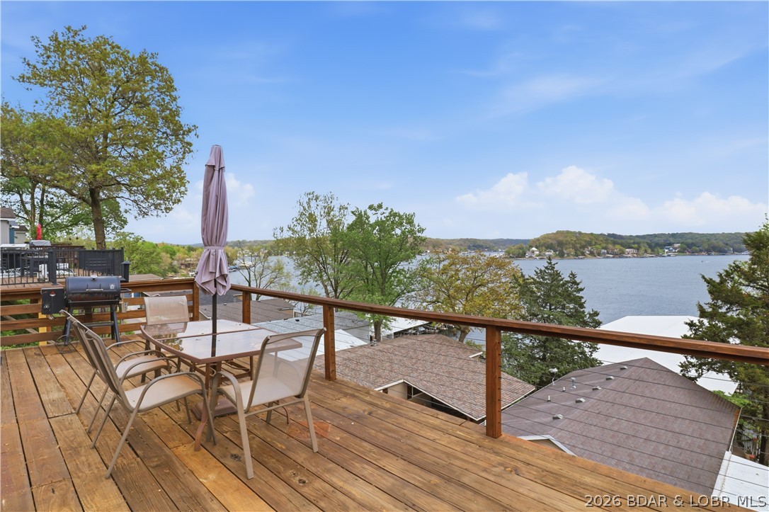 Wake up to beautiful lake sunrises at this turnkey retreat on the Gravois Arm at the 4-mile marker of Lake of the Ozarks. This renovated 2-bedroom, 2-bath home offers just over 1,000 square feet of comfortable lake living w/ modern upgrades, wonderful views, & easy access to your boat slip & lift just a short walk away. Step inside to find LVP flooring throughout & a thoughtfully updated interior designed for easy maintenance & relaxed lake living. The kitchen features a newer gas stove & modern finishes, while the open layout provides a welcoming space for gathering with family & friends after a day on the water. A newer HVAC system provides year-round comfort, and smart home features—including a wireless thermostat and keyless entry—add convenience whether you’re arriving for the weekend or heading out on the lake. Outside, the newly rebuilt deck offers the perfect place to enjoy morning coffee while taking in peaceful lake views and stunning sunrises. With quick & easy access to your boat slip & lift, getting out on the water is effortless. With modern renovations, incredible lake views, & a welcoming atmosphere, this turnkey property is the perfect weekend lake family getaway.