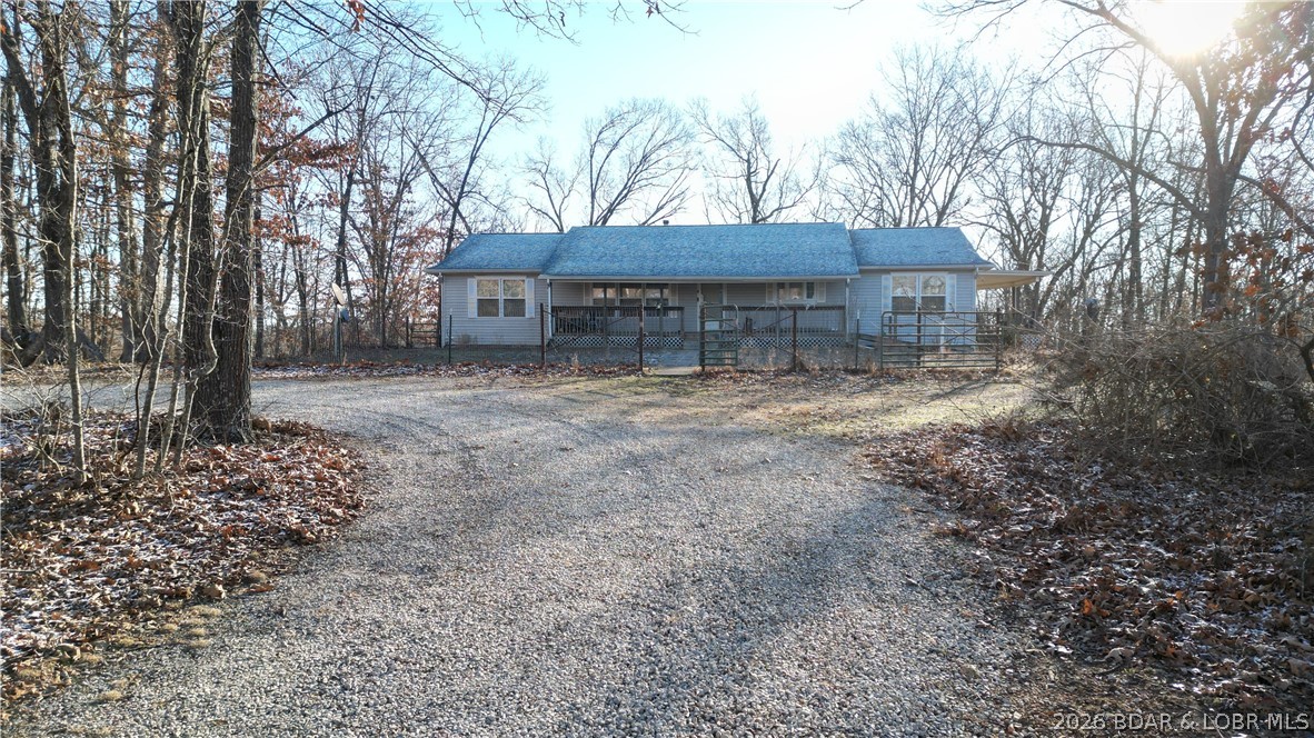 Rare opportunity to own 97 mostly wooded acres just minutes from the lake, offering privacy, recreation, & endless potential. This move-in ready manufactured home features 3 bedrooms, 3 full bathrooms, & two non-conforming rooms, providing flexible space for guests, an office, or hobby rooms.The open-concept living area includes a spacious living room with a cozy wood-burning stove & a large eat-in kitchen filled with natural light and plenty of room for gathering. The main level offers three bedrooms, laundry, & a generous primary suite with a private bathroom, great closet space, & deck access for convenient one-level living.The partially finished walk-out basement adds additional living space with a second living area and bar, a full bathroom, & rooms ready to be finished into extra bedrooms, office space, or guest quarters. Outside you’ll find an oversized one-car attached garage & a 30x40 pull-through shop with concrete floors and electric, ideal for equipment, hobbies, or lake toys.With 97 wooded acres, abundant wildlife, & close proximity to the lake, this property offers the perfect combination of country living, recreation, & convenience. Schedule your showing today!