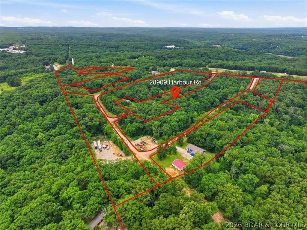 Exceptional 224± acre development opportunity in Gravois Mills, MO, at the Lake of the Ozarks. Originally planned as The Villas of Harbour Hills, this property offers approximately 196 acres of developable land, 19 acres of Commercial space, 9 acres including a Clubhouse. Significant investments have already been made, with wet and dry utilities extended throughout portions of the development. The existing Water Tower and Well is rated to service up to approximately 350 homes, providing a substantial advantage for future development.  The property's rolling terrain, mature timber, scenic views, and natural beauty create an ideal setting for residential, mixed-use, resort, or recreational projects. Lake access at the back of a protected cove enhances the property's appeal and development potential.  Conveniently located near marinas, golf courses, restaurants, and other Lake of the Ozarks attractions, this rare offering provides developers, builders, and investors the opportunity to continue the original vision or create an entirely new destination community in one of Missouri's premier recreational markets.
