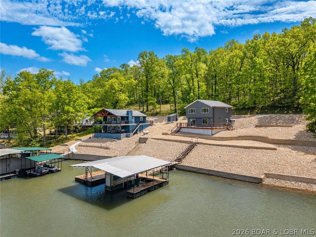 Tucked away in a quiet cove with 100 feet of shoreline, this beautifully remodeled lakefront retreat offers the perfect blend of privacy, functionality, and modern style. Completely updated in 2026, this 3 bedroom, 3 bath home is move-in ready and designed for easy lake living.  Step inside to a stunning kitchen featuring a large island, stainless steel appliances, and high-end finishes—ideal for hosting family and friends. Master suite offers beautiful custom tiled walk in shower. The open layout flows seamlessly to a spacious deck and a flat yard area perfect for a fire pit, yard games, or relaxing evenings by the lake. Enjoy easy access to the dock, along with a larger dock envelope and room to expand.  The oversized lot gives plenty of room to add a garage. New septic just installed.  The address says it all... this home is ready for you start Relaxing at the lake!