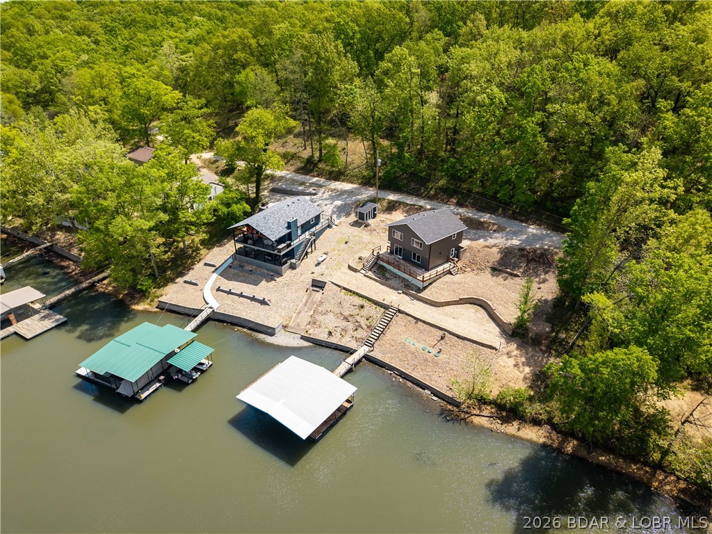 Tucked away in a quiet cove with 100 feet of shoreline, this beautifully remodeled lakefront retreat offers the perfect blend of privacy, functionality, and modern style. Completely updated in 2026, this 3 bedroom, 3 bath home is move-in ready and designed for easy lake living.  Step inside to a stunning kitchen featuring a large island, stainless steel appliances, and high-end finishes—ideal for hosting family and friends. Master suite offers beautiful custom tiled walk in shower. The open layout flows seamlessly to a spacious deck and a flat yard area perfect for a fire pit, yard games, or relaxing evenings by the lake. Enjoy easy access to the dock, along with a larger dock envelope and room to expand.  The oversized lot gives plenty of room to add a garage. New septic just installed.  The address says it all... this home is ready for you start Relaxing at the lake!