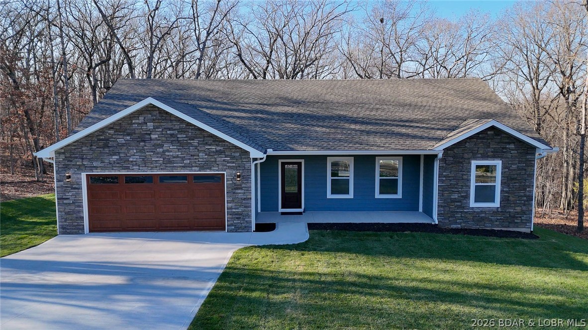 Brand-new beautiful home in the highly sought-after subdivision within Porto Cima! Located on a quiet cul-desac off the main drag of Grand Point & situated on wooded lot that backs up to POA property to ensure privacy & serenity. This thoughtful build has an open concept design for everyday convenient main floor living. The layout flows seamlessly from the bright great room with vaulted ceilings, to stylish kitchen featuring quartz countertops, stainless farm sink, crown moulding & LVP flooring throughout. Enjoy morning coffee on the covered porch or unwind in the evening on your trex deck. Master suite with large picture windows, huge walkin shower w/ stunning floor to ceiling tile & even a electronic bidet! Spoil yourself in either bath with jetted shower control bars and quartz vanities. Extra details like LED halo lightning, large ceiling fans, & hyper HVAC system for affordable utilities. Plus a finished 2 garage that is heated/cooled for year round comfort! Get access to incredible community amenities—pickleball courts, tennis courts & pool—perfect for active lifestyle. Ideal comfortable living with a beautiful yard in a great neighborhood- come see today!
