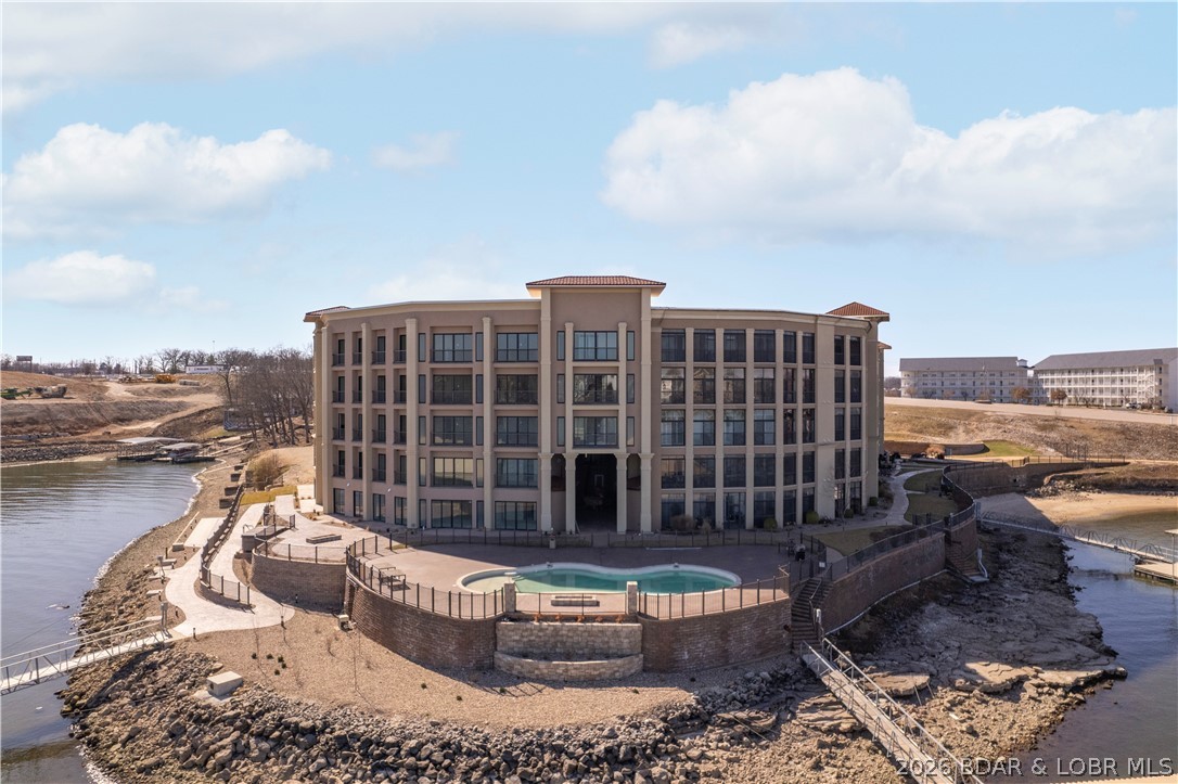 Developer units for sale at The Hamptons in Osage Beach. Lower level unit with a nice patio area and direct access to the lake! Step into a world where luxury meets serenity. This gated community is just a short walk to The Oasis, Dog Days and several other lake attractions. With only a limited number of 4 bedroom units available, experience grand living in the heart of Osage Beach. These new construction condos have the same great Hamptons on the Lake amenities & location but this is a different builder/developer than the previous buildings. New amenities were also added, a hot tub by the pool, fitness center, clubhouse, lakeside shuffleboard court, fire pits & a wonderful swim dock! Between the buildings is also a resort-style breezeway. Relax, connect, and unwind in this lounge-setting area against a backdrop of the lake and pool. It is rare to find 4 bedroom condo units at the lake. When you add that this complex doesn't allow nightly rentals, offers 2,600 sq ft, and 4 baths all in this location, Forget about it, this is the one. Finishes are all top notch so stop in today to learn more about these new construction condos. Boat slips are available to purchase up to 18X48.